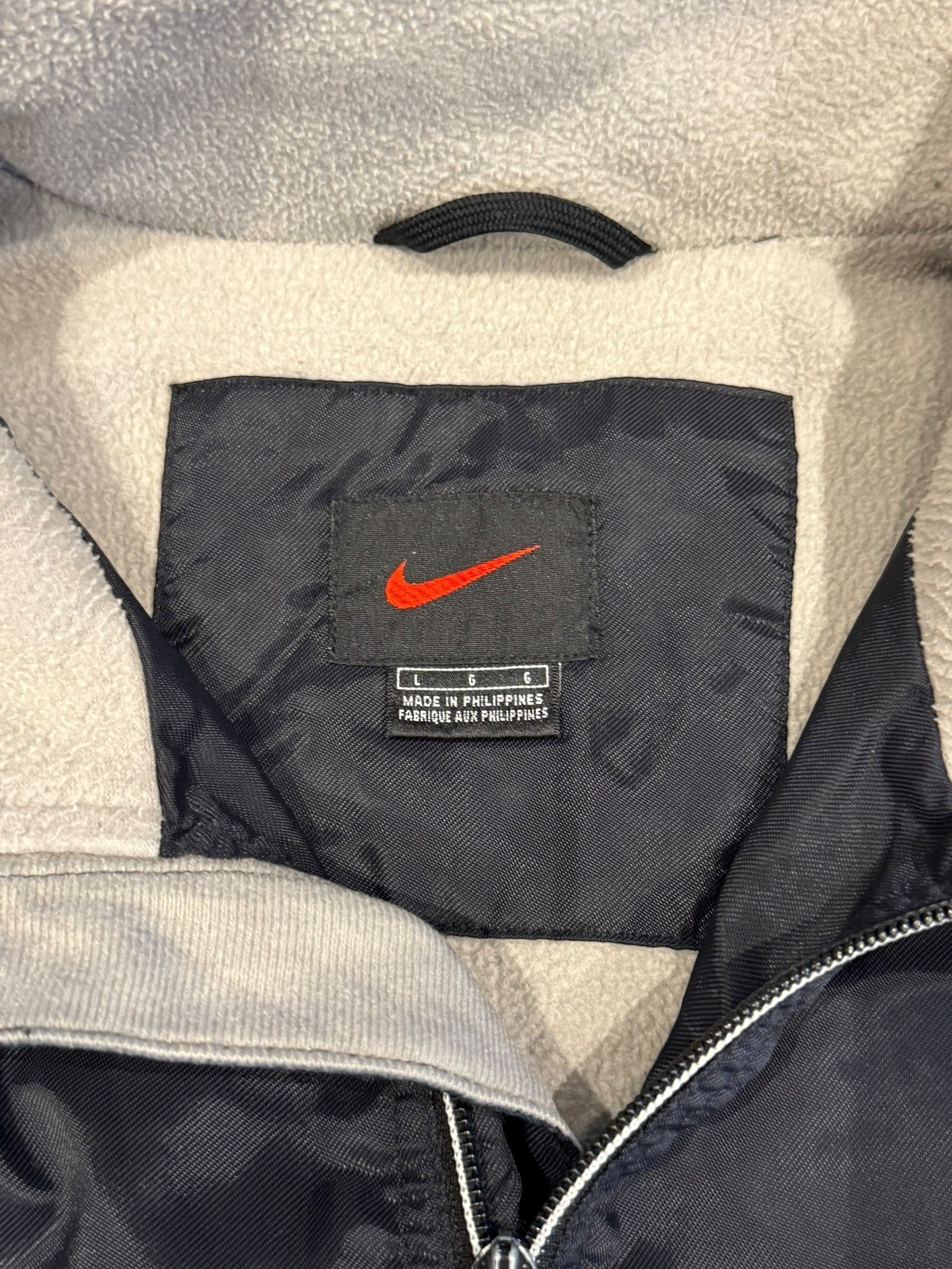 Archive No. 9 Nike black training jacket, size L, water and wind resistant with fleece lining.