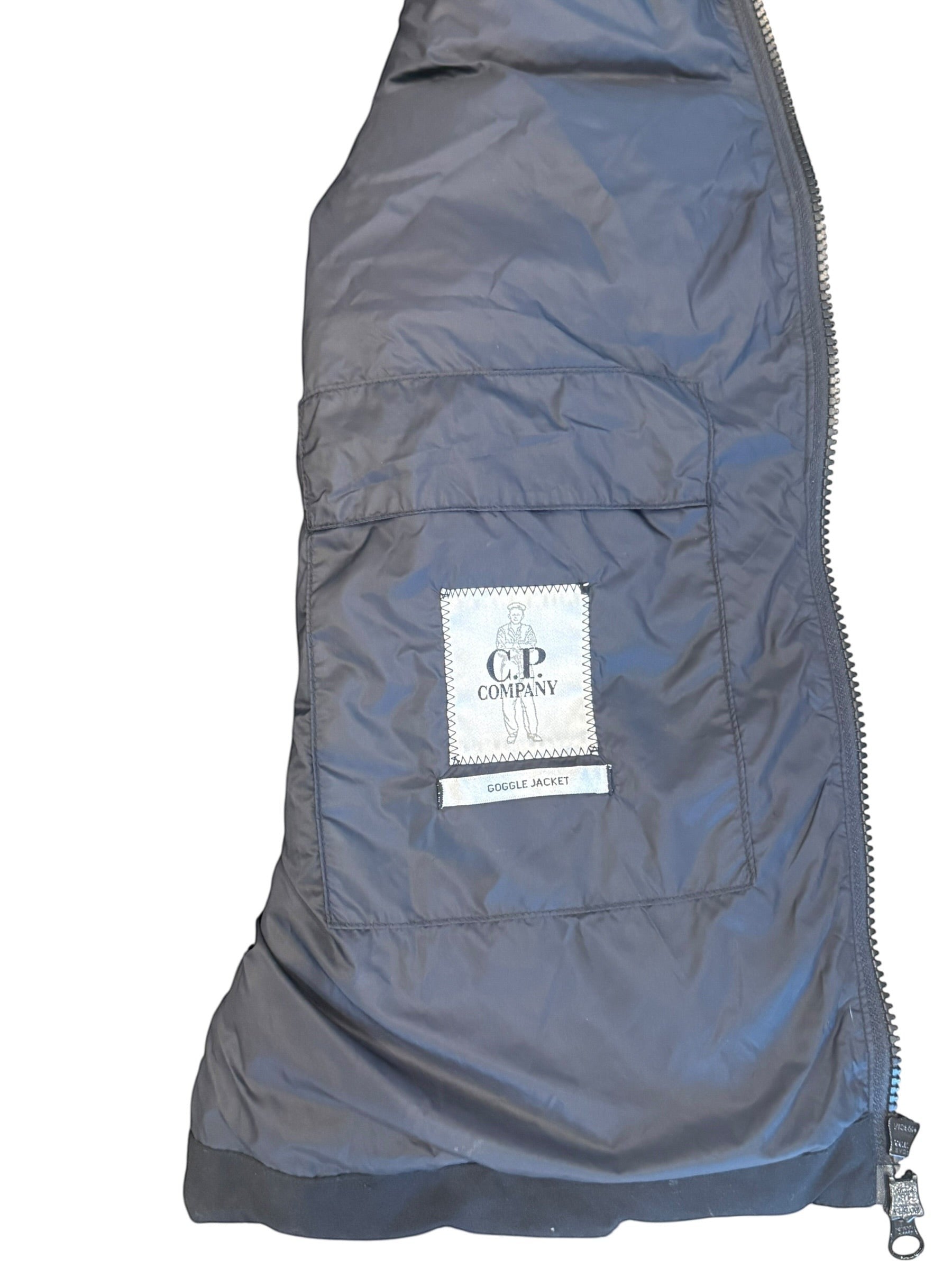 Archive No. 9 C.P. Company black hybrid puffer jacket with detachable hood and 50/50 knit material.