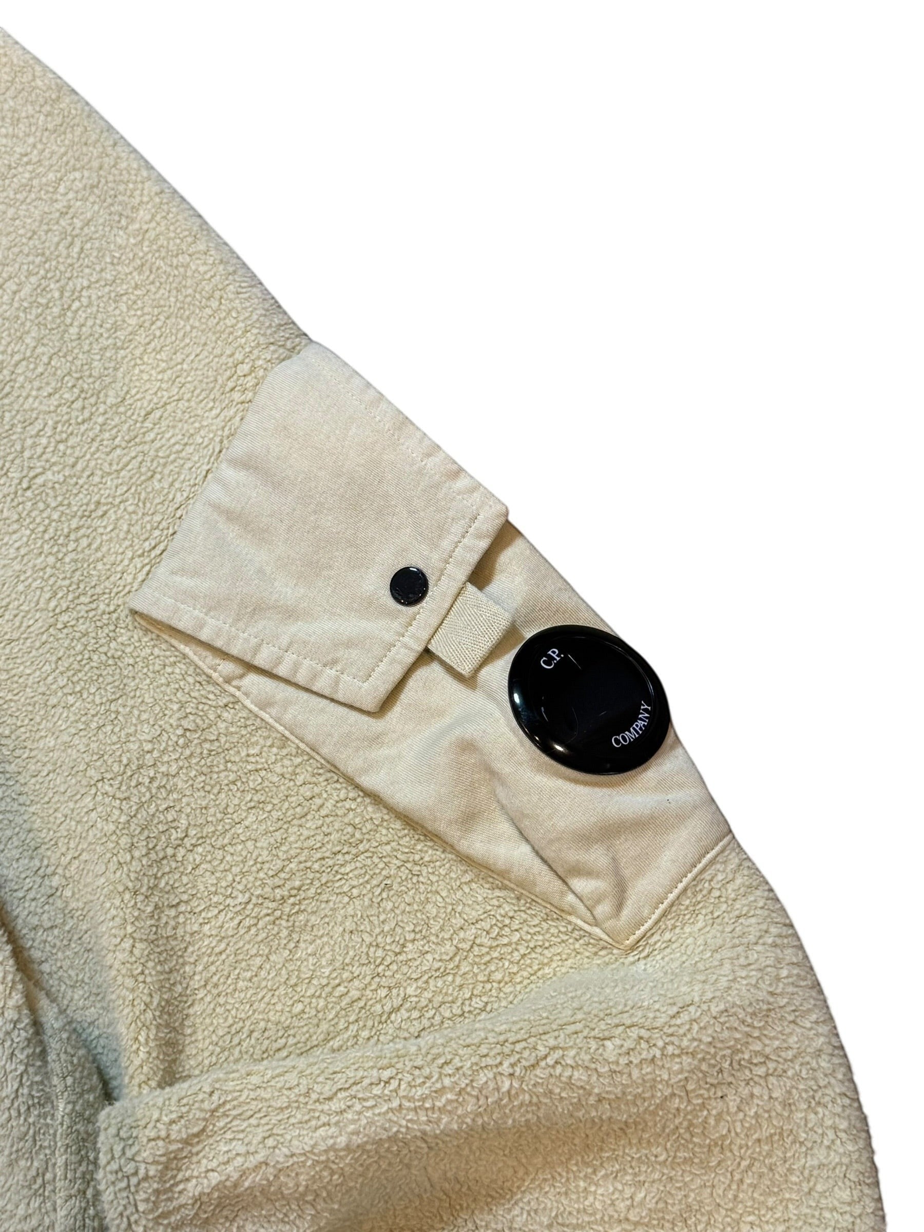 Archive No. 9 beige Fleece Jumper with C.P. Company lens detail on sleeve.