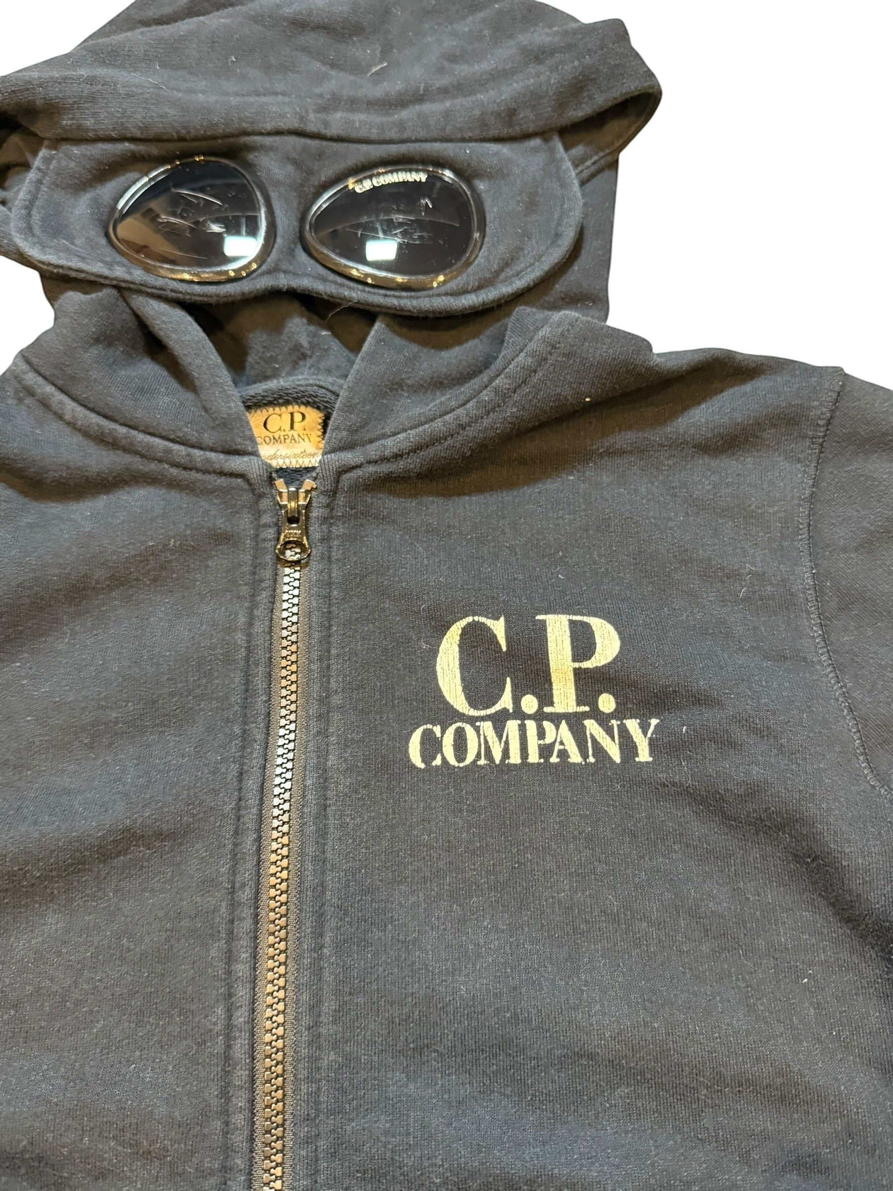 Archive No. 9 black cotton C.P. Company zip-up hoodie with integrated goggles on the hood and front logo.