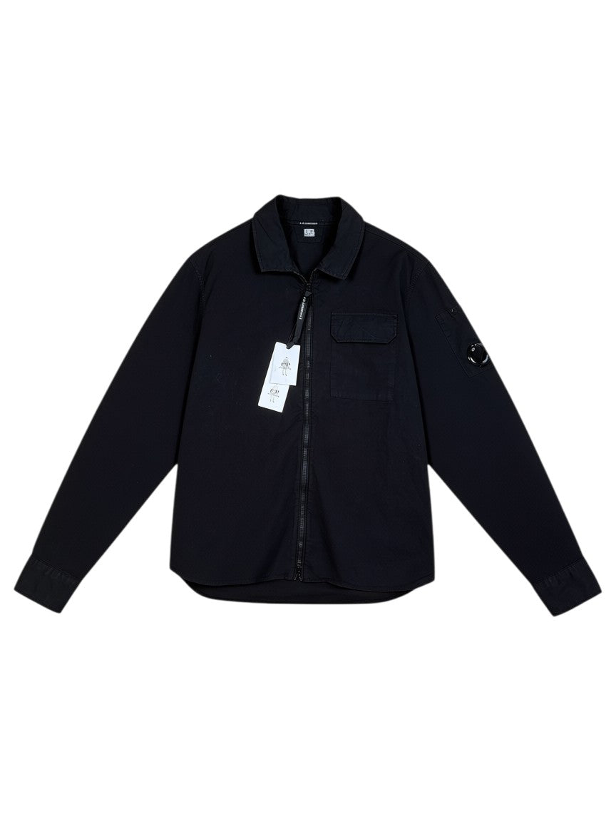 Archive No. 9 black 100% cotton C.P. Company overshirt with zip front, chest pocket, and iconic lens detail on sleeve. Size S.