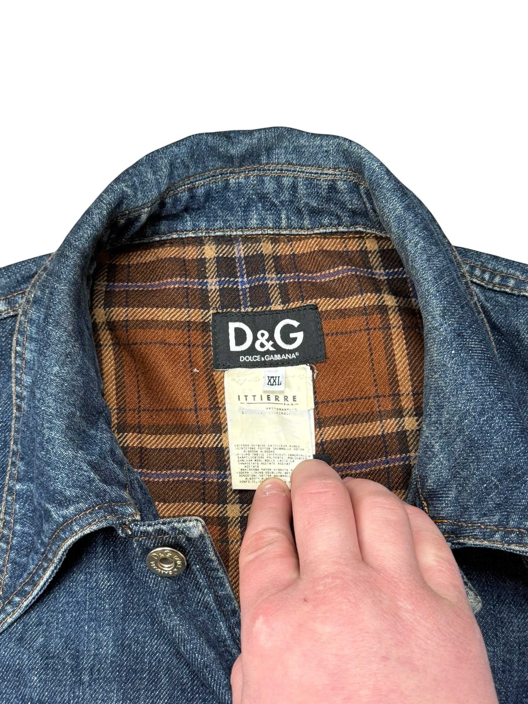 Archive No. 9 blue denim jacket with a brown and blue checkered interior lining. Button-up front and 100% cotton.