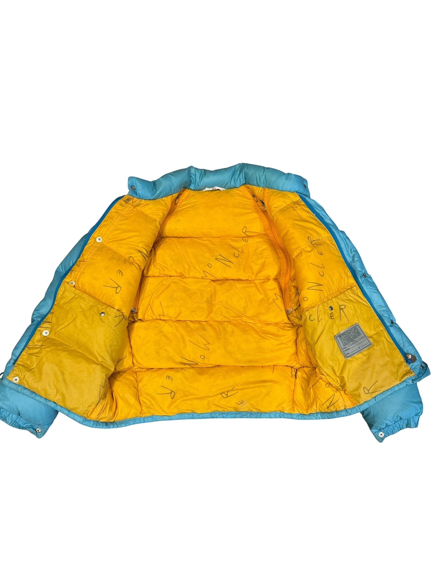 Archive No. 9 vintage blue Moncler down puffer jacket with yellow lining and detachable sleeves.