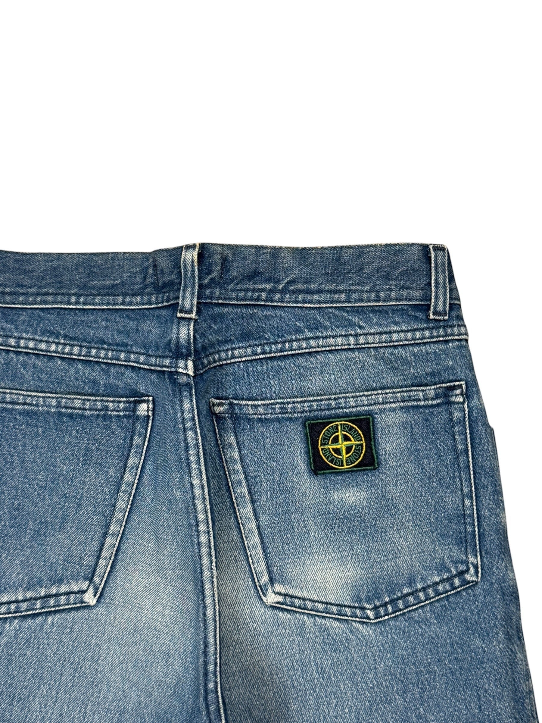 Archive No. 9 vintage blue denim jeans with green edge Stone Island badge on back pocket, size W30.