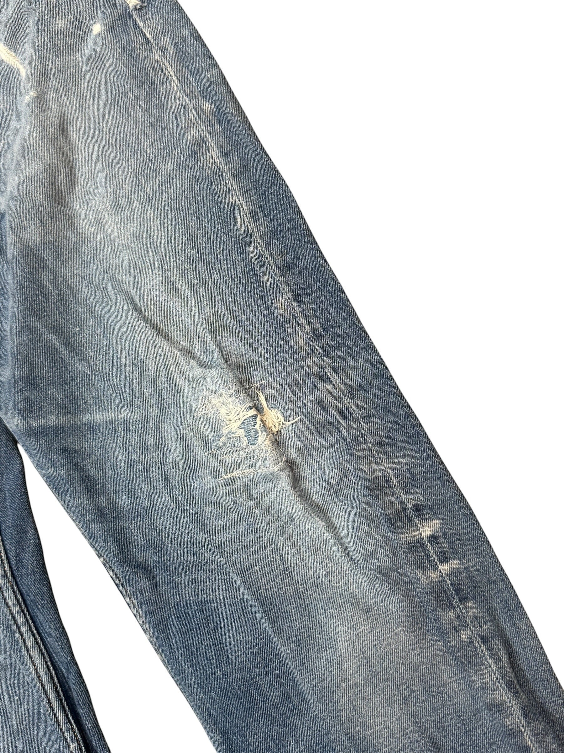 Archive No. 9 vintage blue denim jeans, size W32, with distressed details and iconic Stone Island compass badge on back pocket.
