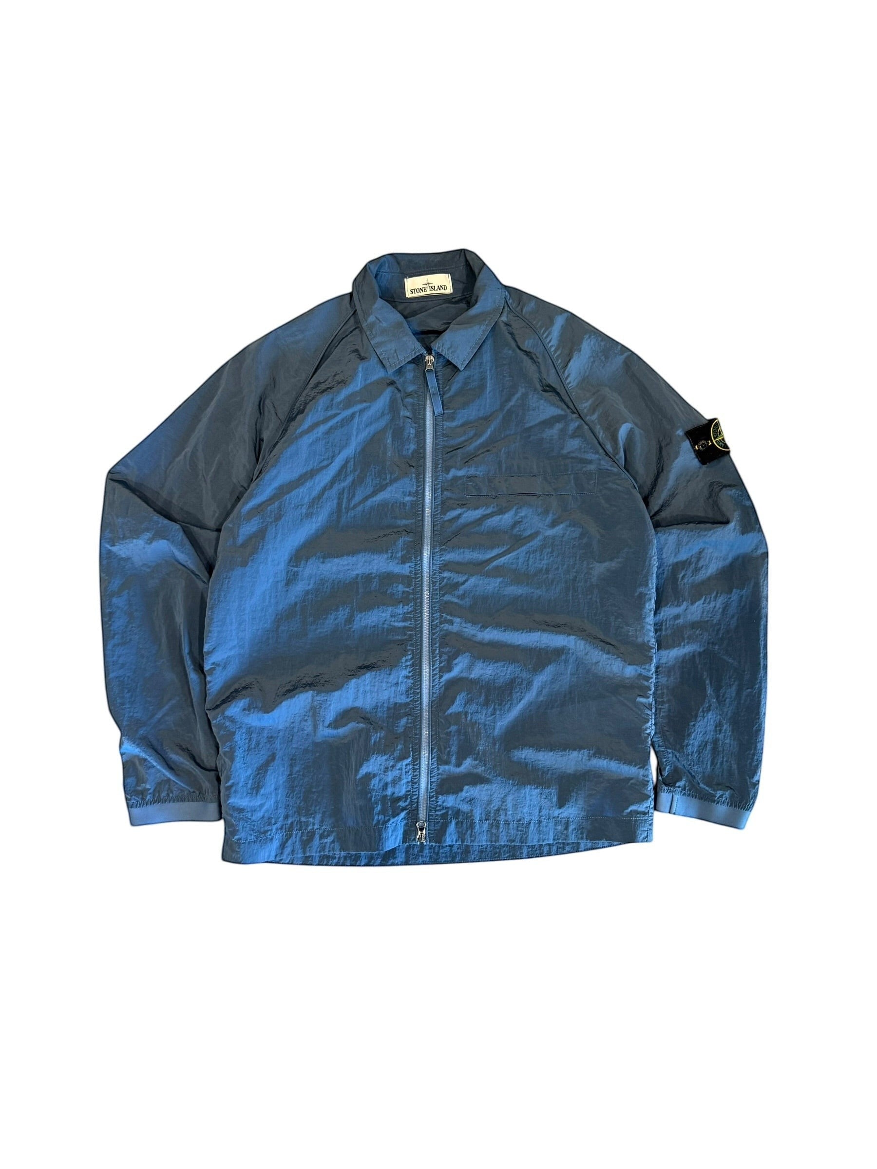Archive No. 9 blue Stone Island nylon jacket, size L. Lightweight, wind and water-resistant with zip closure and signature compass badge.