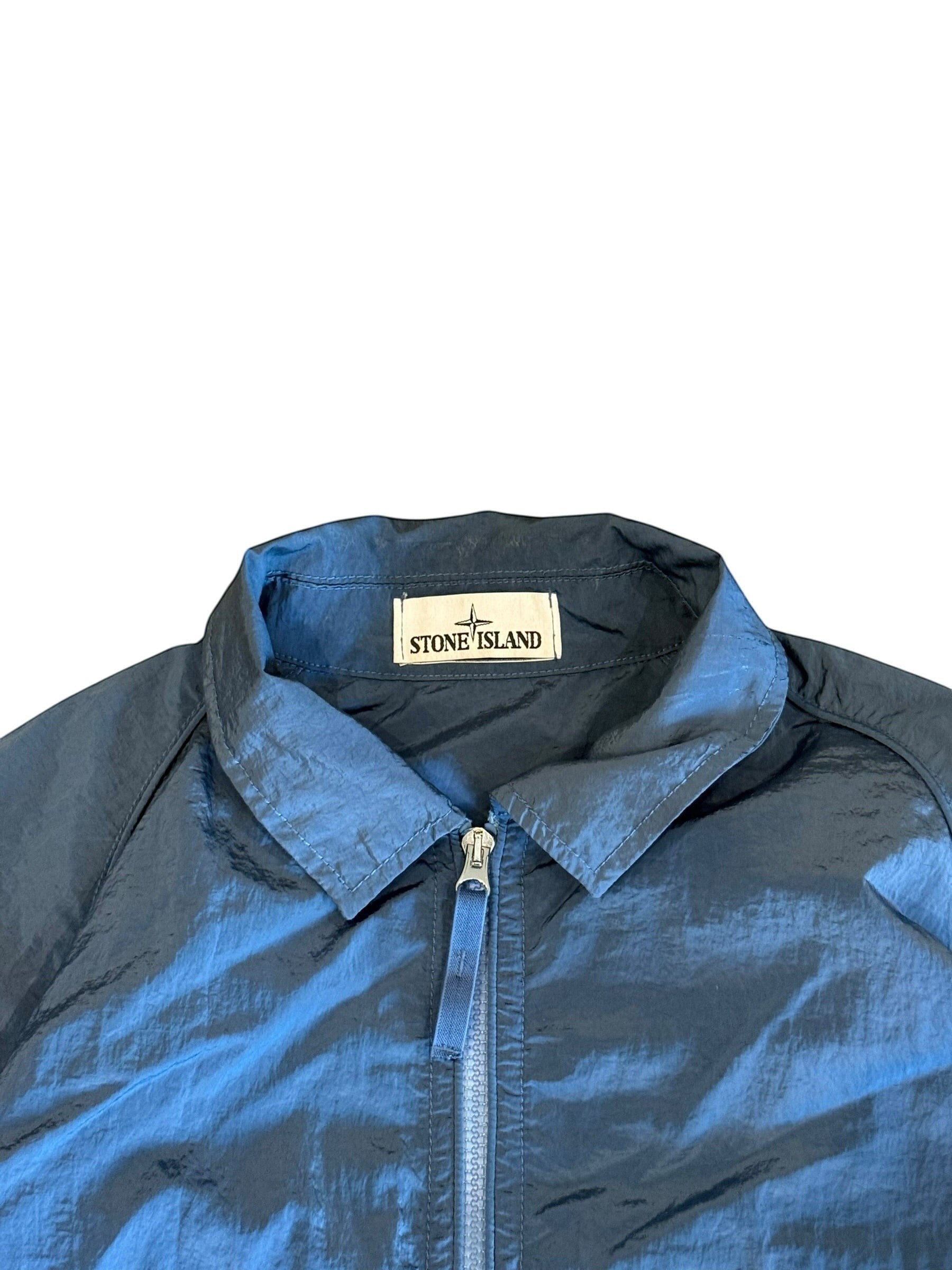 Archive No. 9 blue Stone Island nylon jacket, size L. Lightweight, wind and water-resistant with a zip closure.