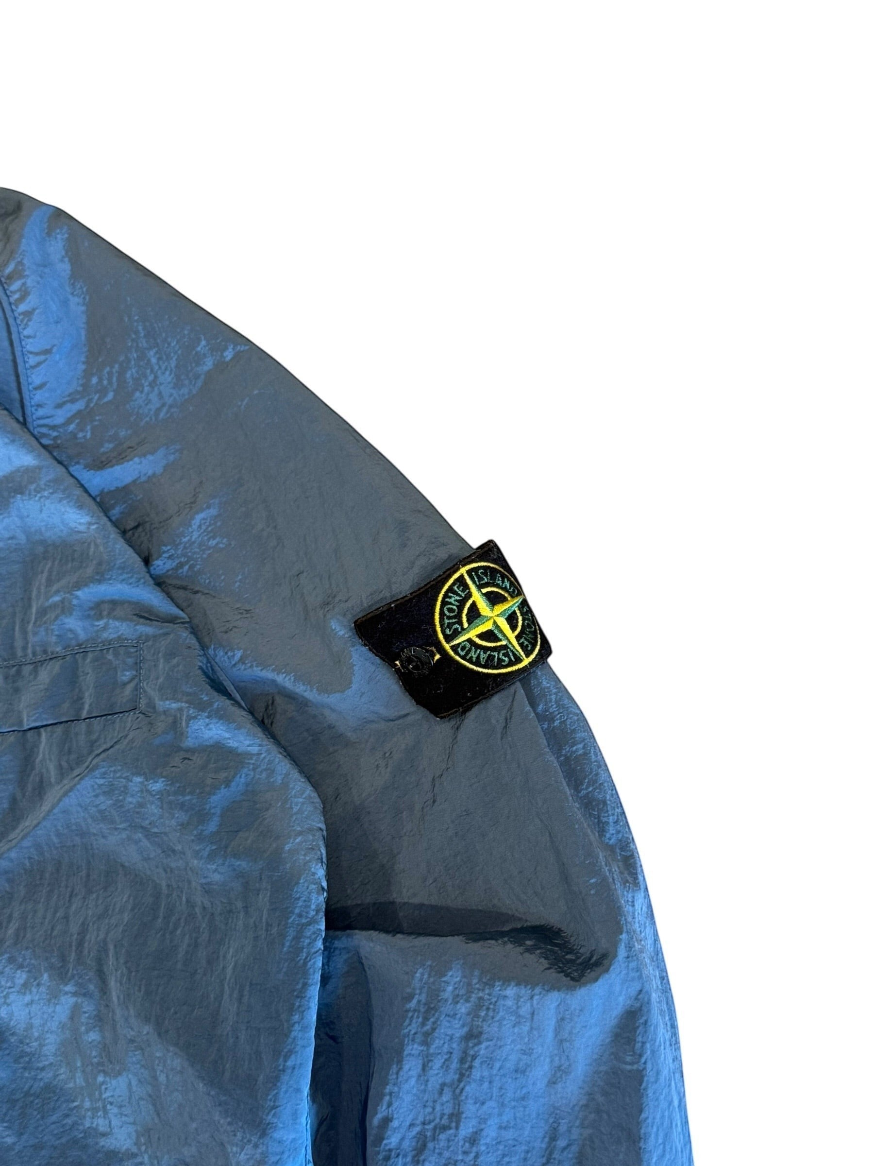 Archive No. 9 blue Stone Island nylon jacket, size L. Lightweight, wind and water-resistant with iconic badge.
