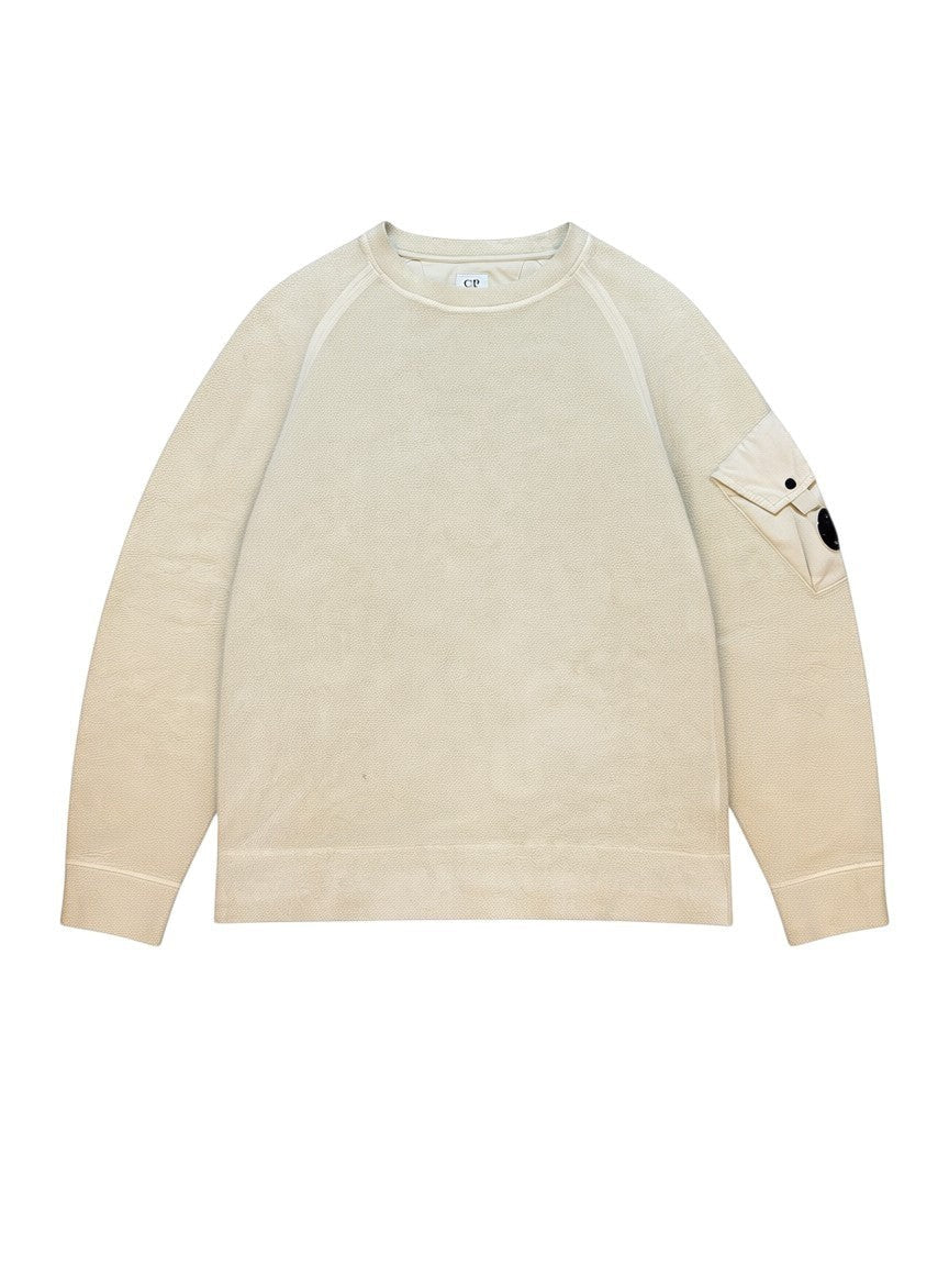Archive No. 9 beige fleeced C.P. Company sweatshirt with iconic arm lens detail.
