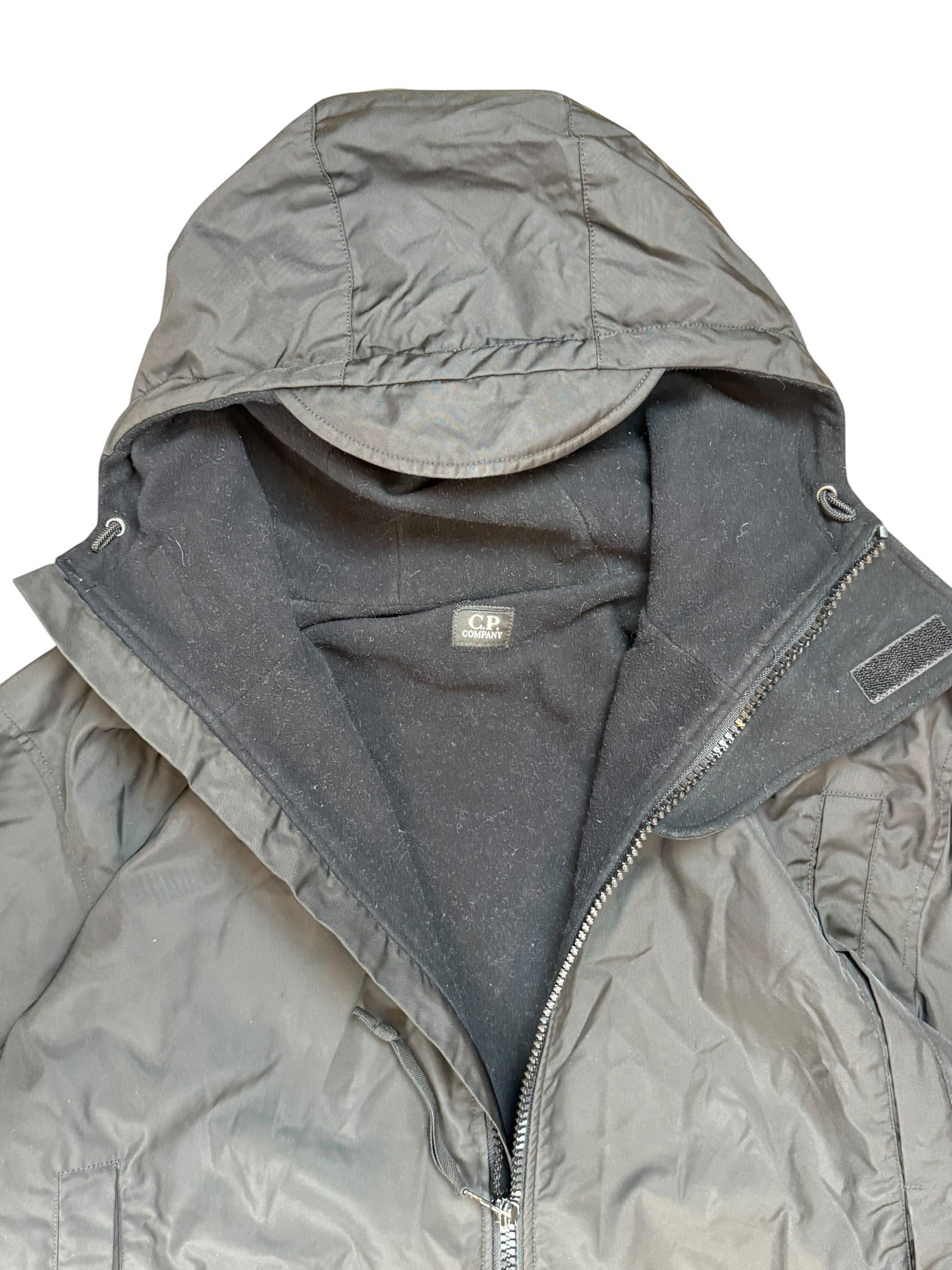 Archive No. 9 black C.P. Company technical parka jacket, vintage 2002, size L, with fleece lining and adjustable hood.
