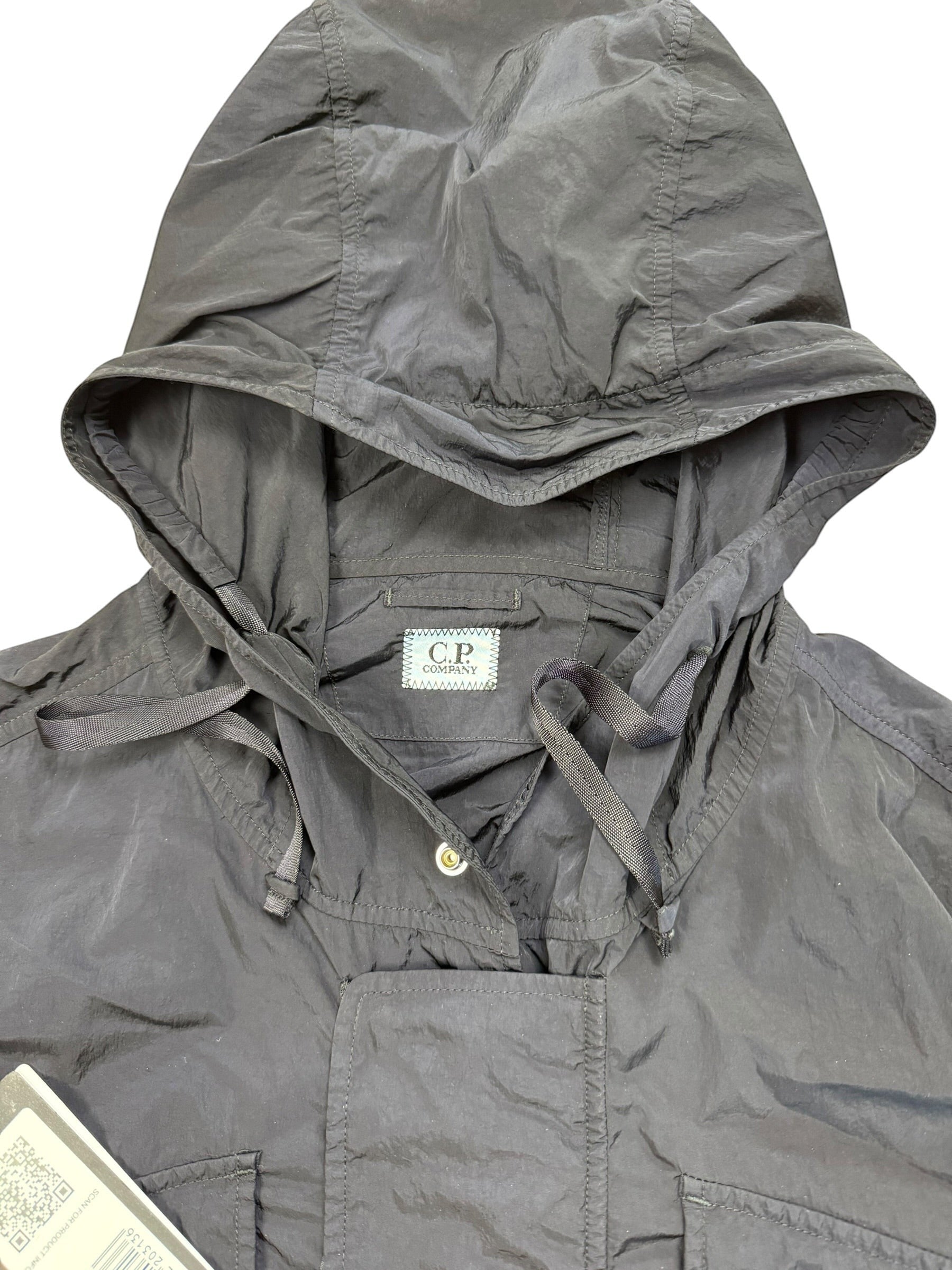 Archive No. 9 C.P. Company black utility windbreaker jacket with hood, multi-pocket design, and waterproof features.