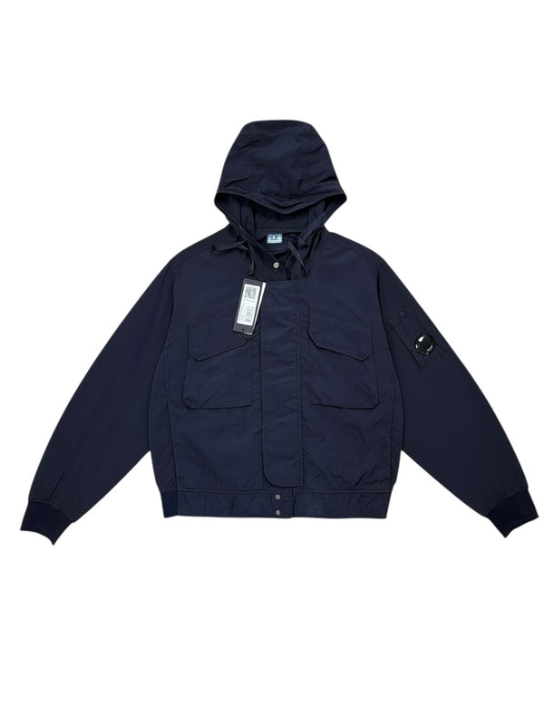 Archive No. 9 black C.P. Company Chrome R utility windbreaker jacket with hood, multiple pockets, and signature lens detail on sleeve. Size L.