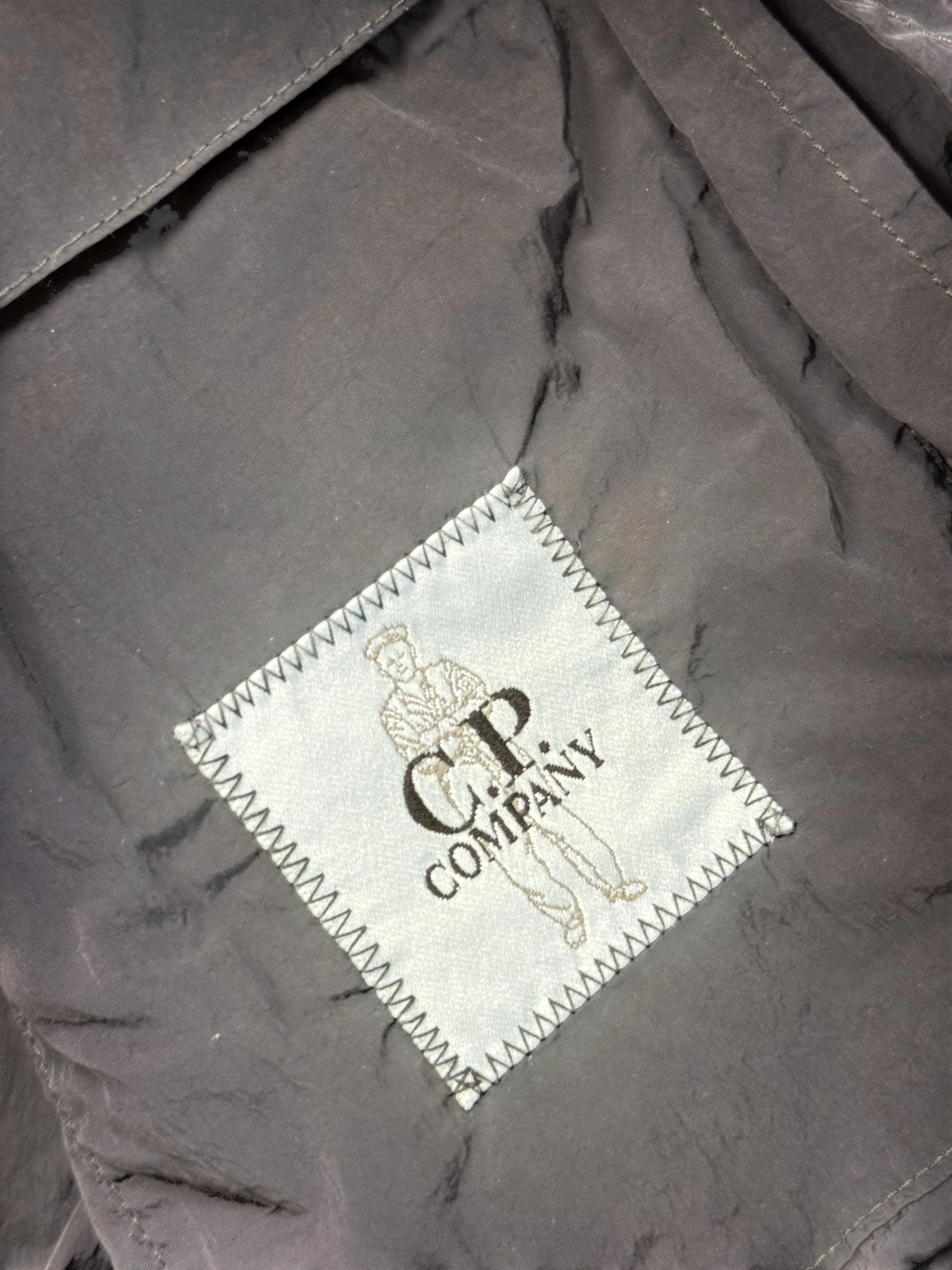 Archive No. 9 C.P. Company black utility windbreaker jacket with multi-pocket design, waterproof and wind-resistant features.