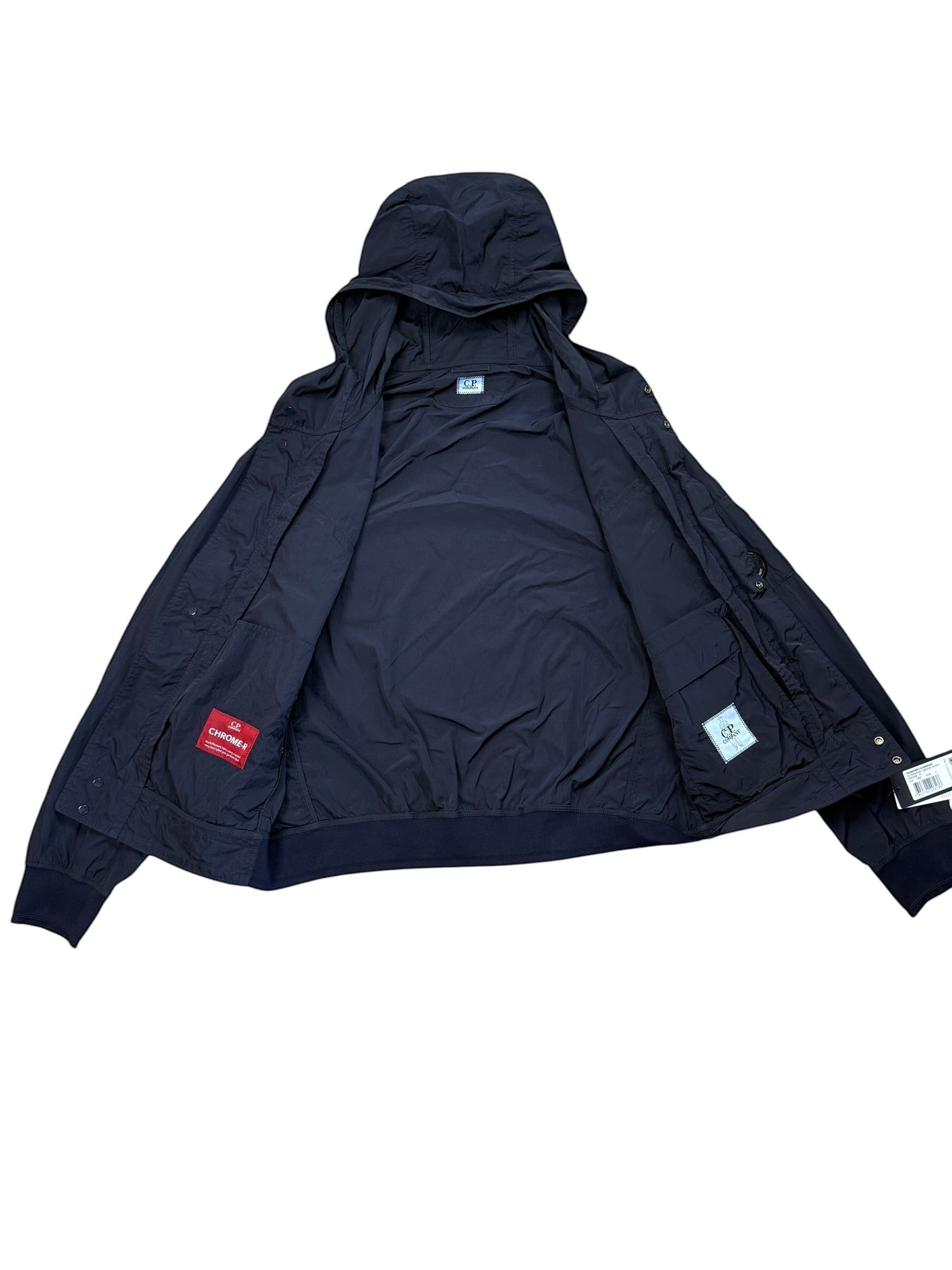 Archive No. 9 C.P. Company black Chrome R utility windbreaker jacket with hood, multiple pockets, and wind/waterproof features.