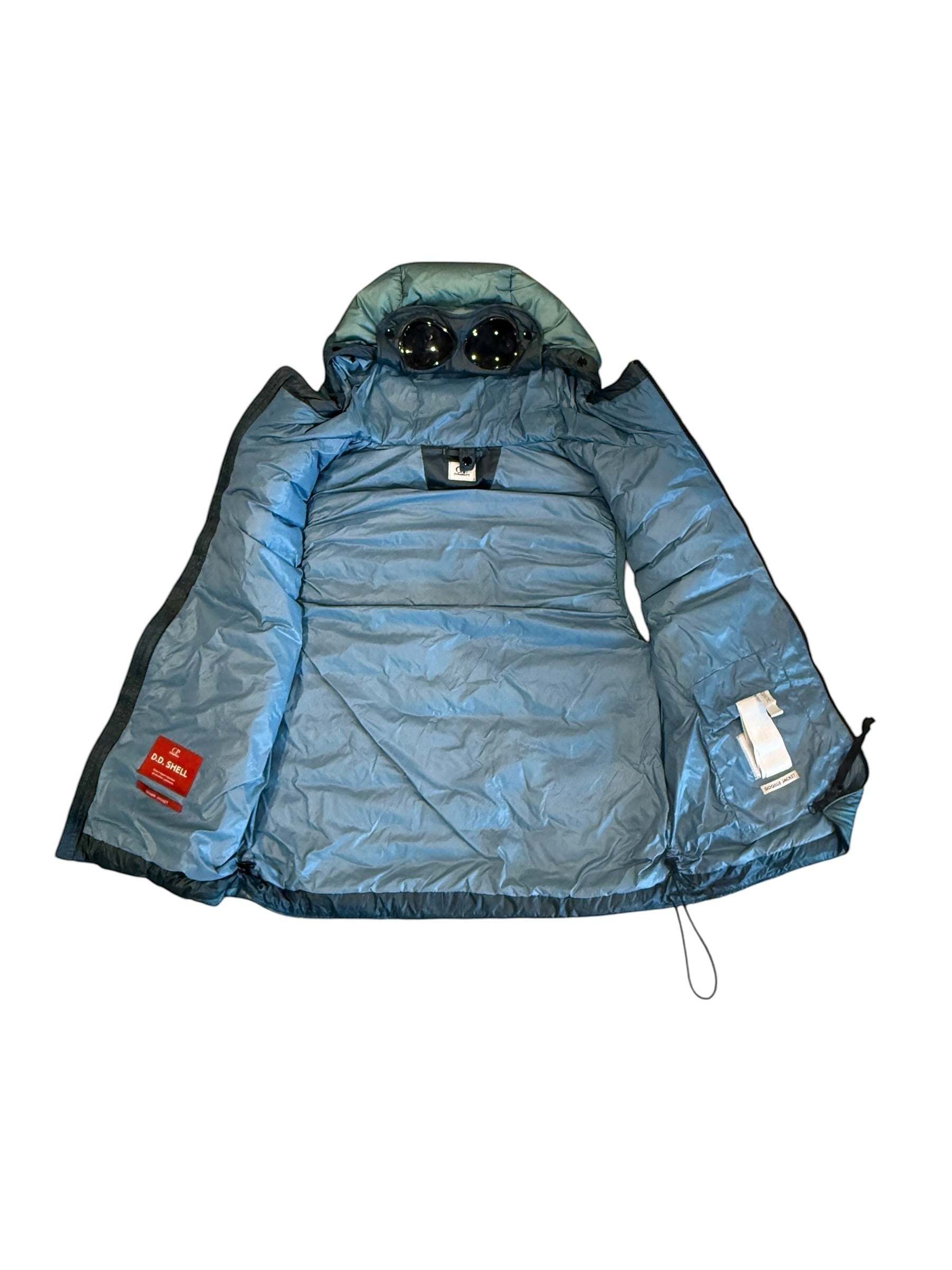 Archive No. 9 blue C.P. Company hooded DD Shell down-filled body warmer, size L, with iconic goggles on hood.