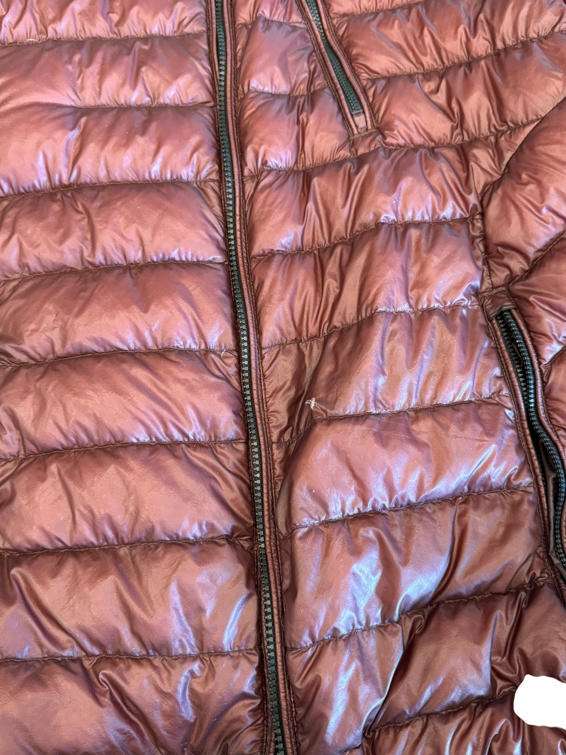 Archive No. 9 C.P. Company burgundy DD Shell puffer jacket, size Large. Features waterproof material and a small front tear.