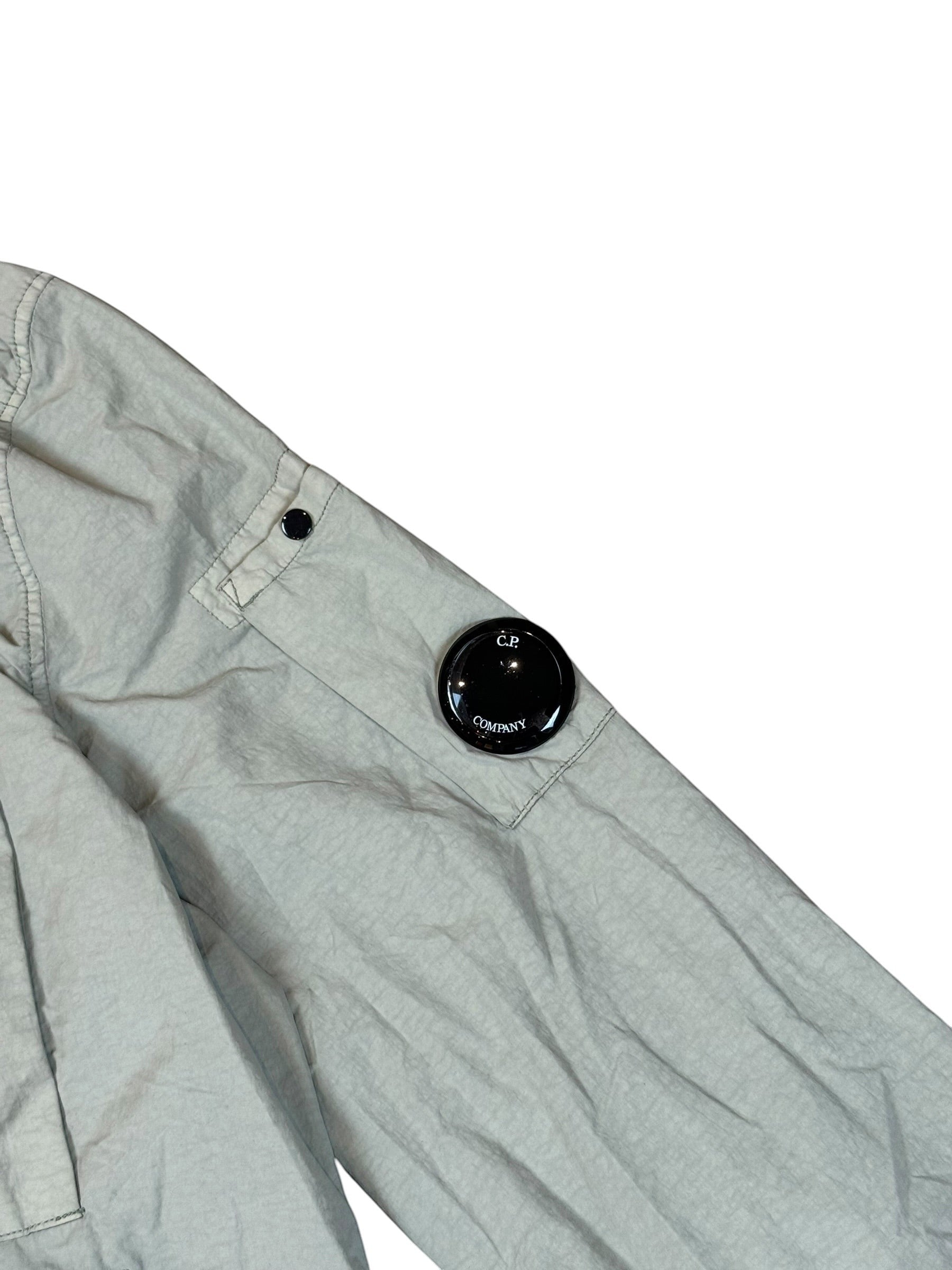Archive No. 9 C.P. Company khaki utility overshirt with multiple pockets and signature lens detail on sleeve, size S.