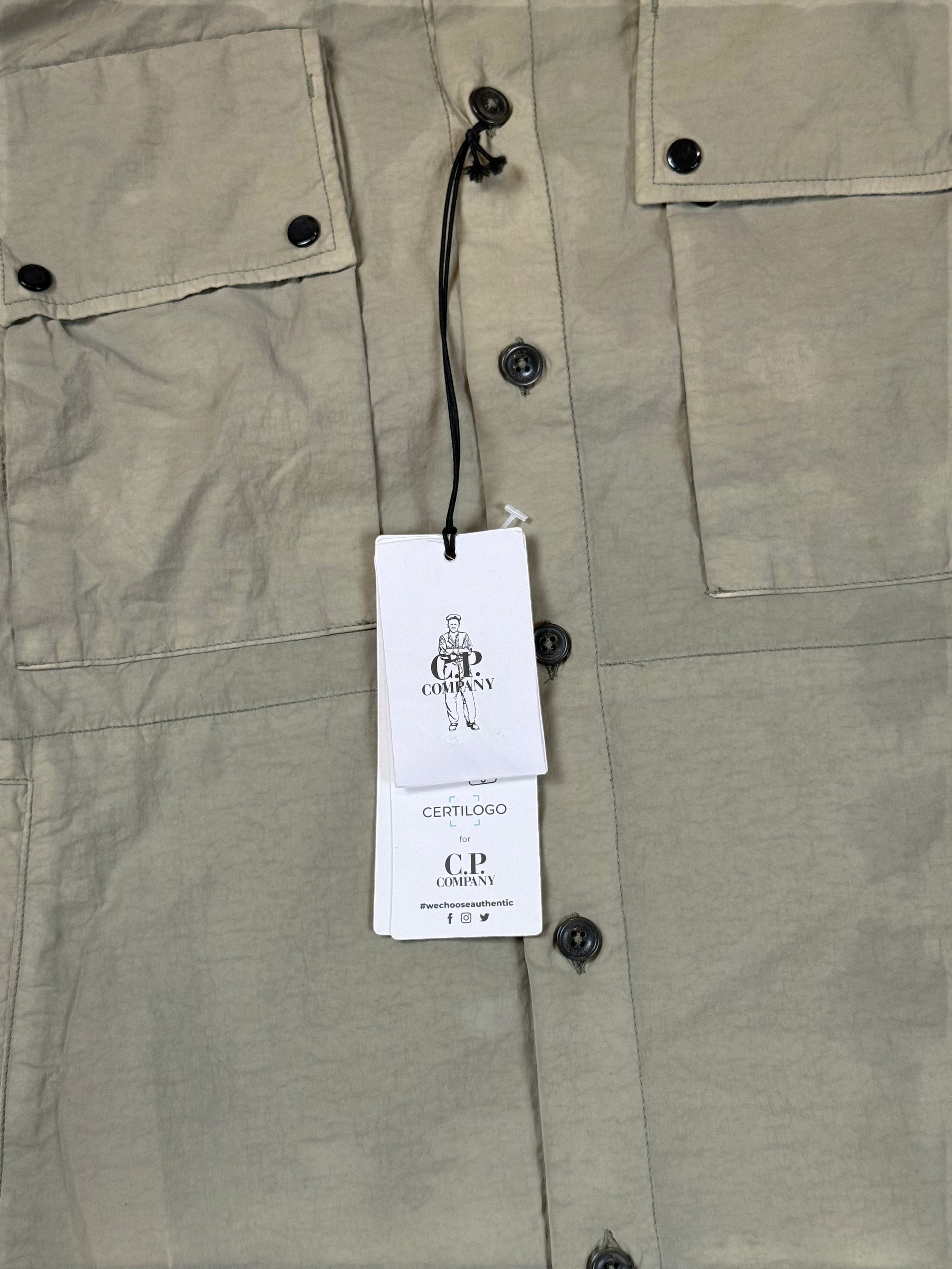 Archive No. 9 khaki C.P. Company utility overshirt in size S, featuring multiple pockets and button closure.