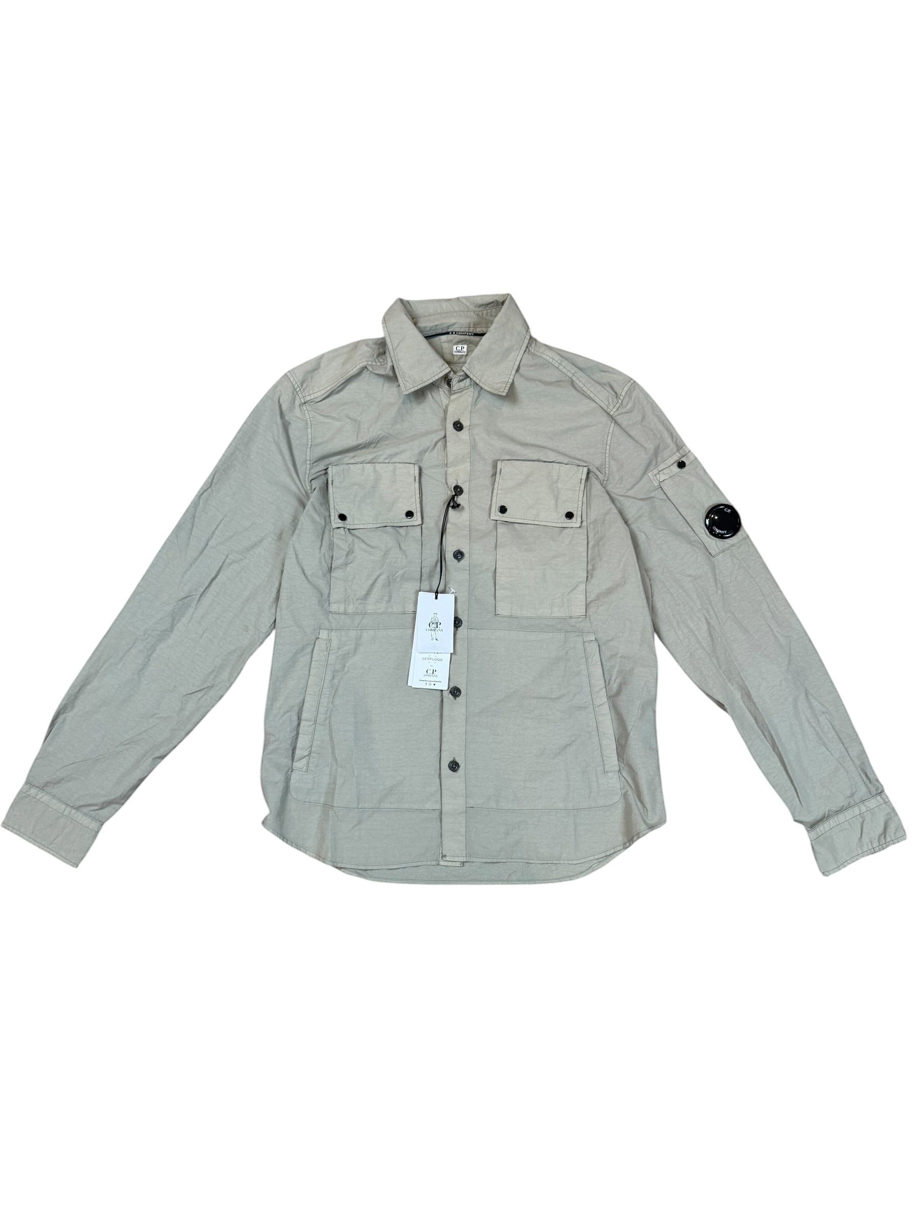 Archive No. 9 khaki C.P. Company utility overshirt with multiple pockets and lens detail on sleeve, size S.