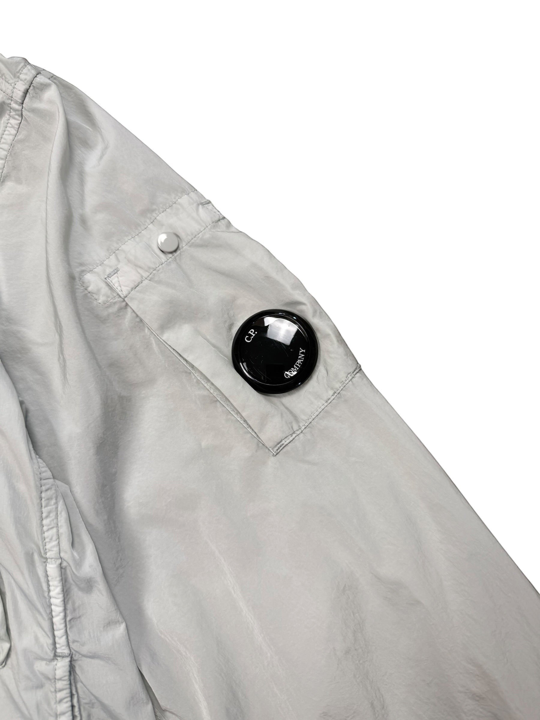 Archive No. 9 C.P. Company light blue Chrome R Utlity Windbreaker jacket with lens detail on sleeve. Lightweight, waterproof, and wind-resistant.