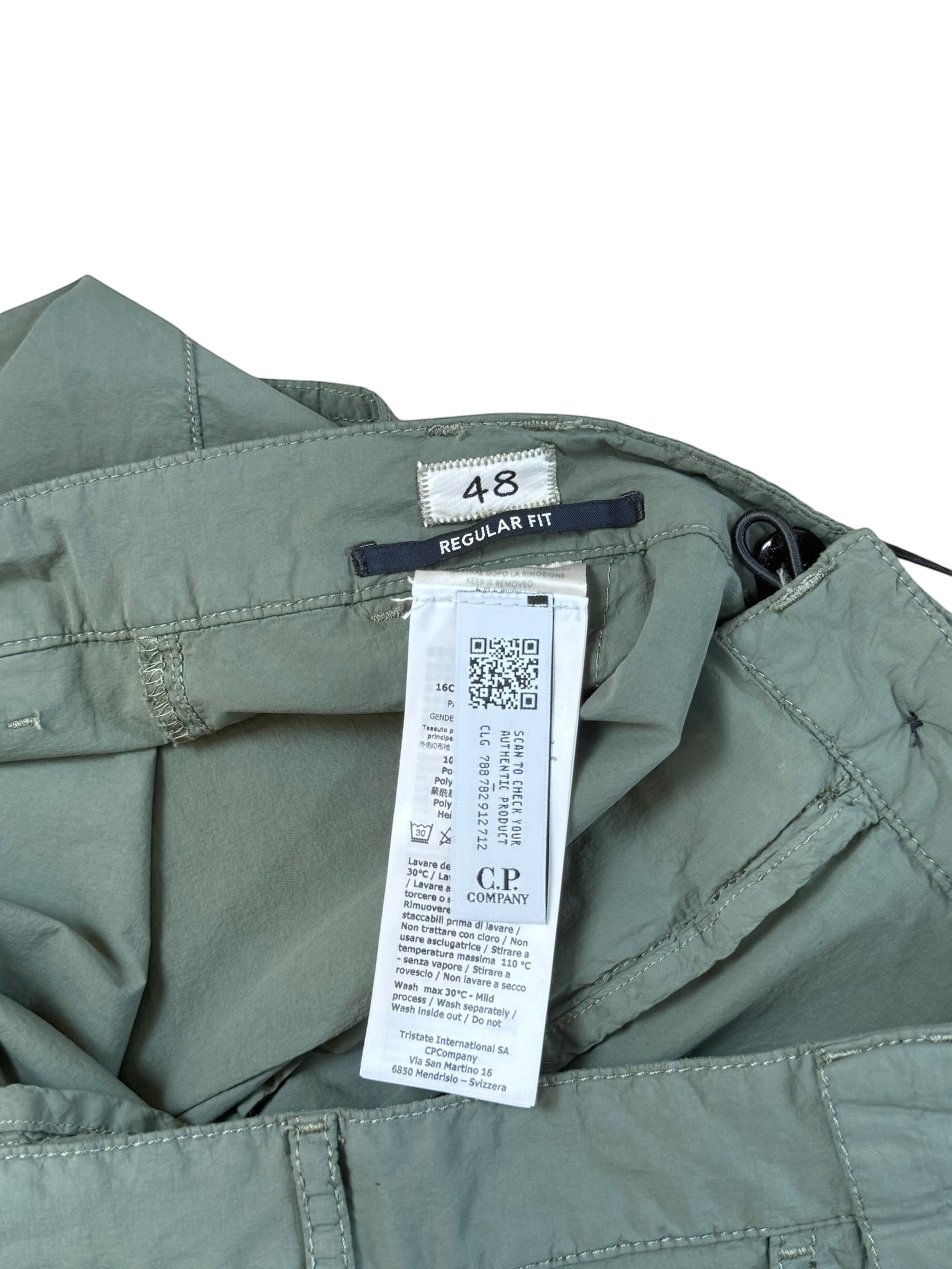 Archive No. 9 C.P. Company dark turquoise lightweight nylon trousers with regular fit and iconic lens detail.