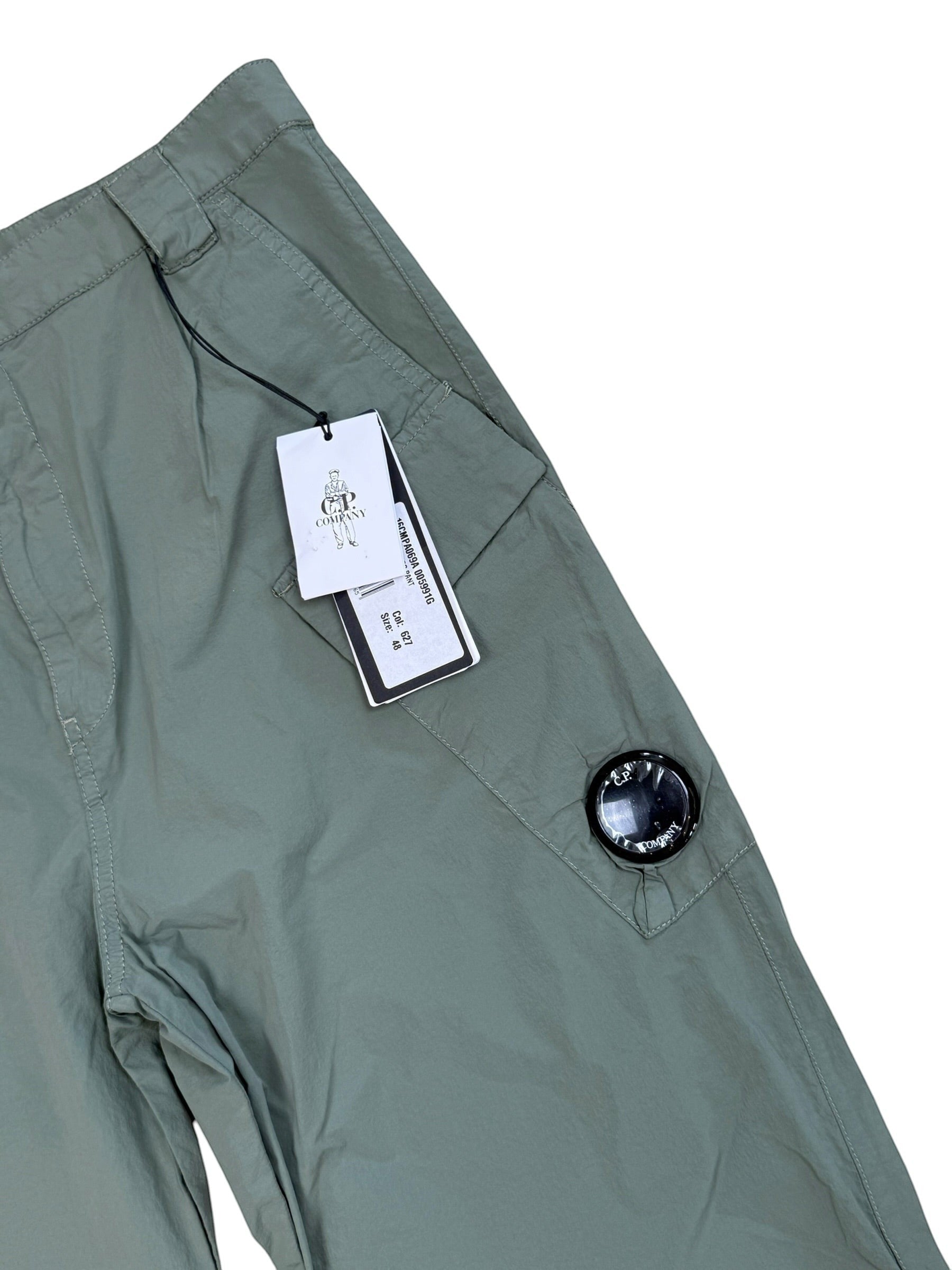 Archive No. 9 C.P. Company dark turquoise nylon lightweight cargo trousers with iconic lens detail.