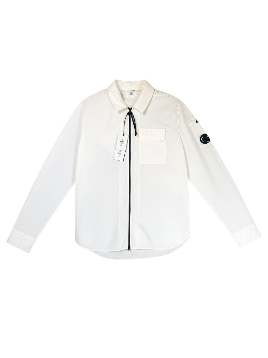 Archive No. 9 white C.P. Company lightweight zip-up overshirt with chest pocket and signature arm lens detail.