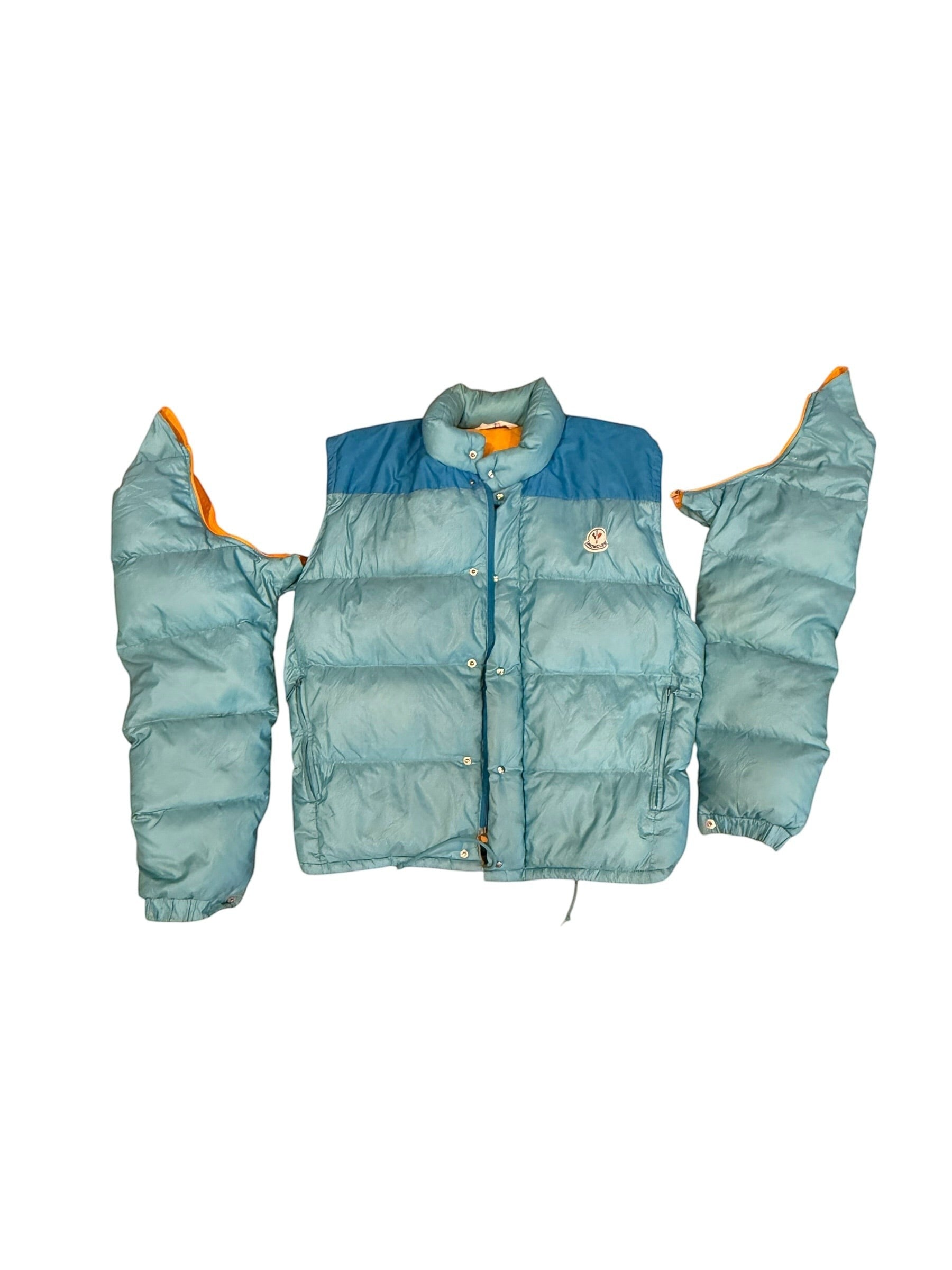 Archive No. 9 vintage Moncler blue down puffer jacket with detachable sleeves and orange lining. Size Medium.