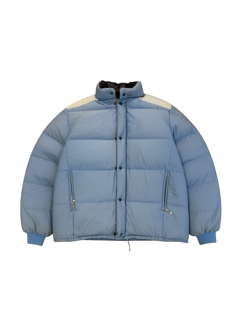 Archive No. 9 Moncler vintage light blue down puffer jacket, size Large. Features contrast cream shoulder panels and elasticated cuffs.