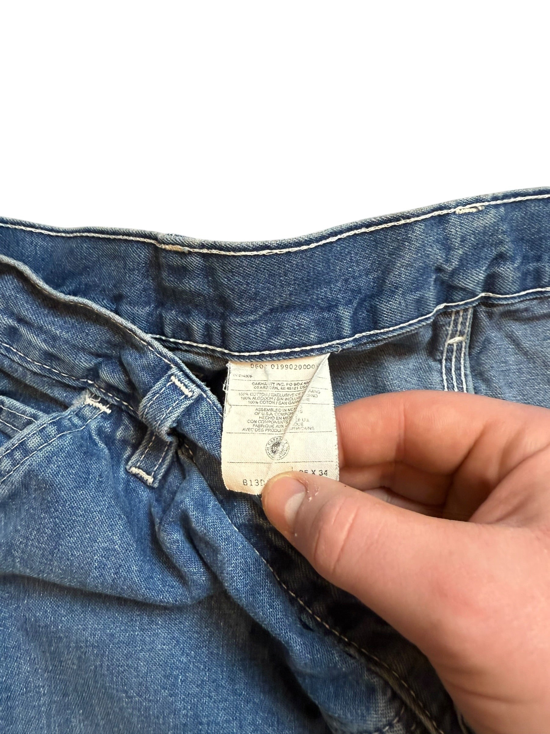 Archive No. 9 vintage navy Carhartt jeans, size W36, made from high-quality denim with a leather patch detail.