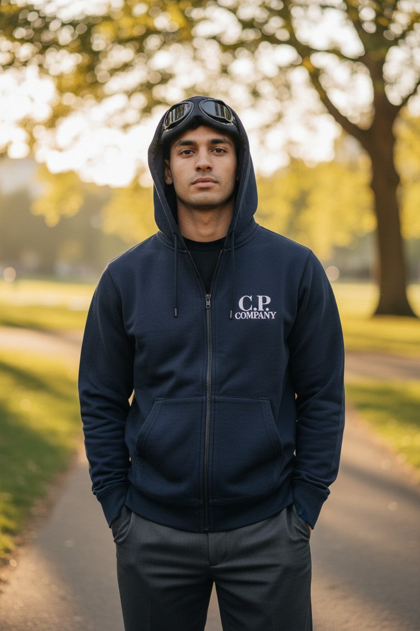 Archive No. 9 navy C.P. Company zip-up hoodie with iconic goggles on the hood and fleeced interior. Size Medium.