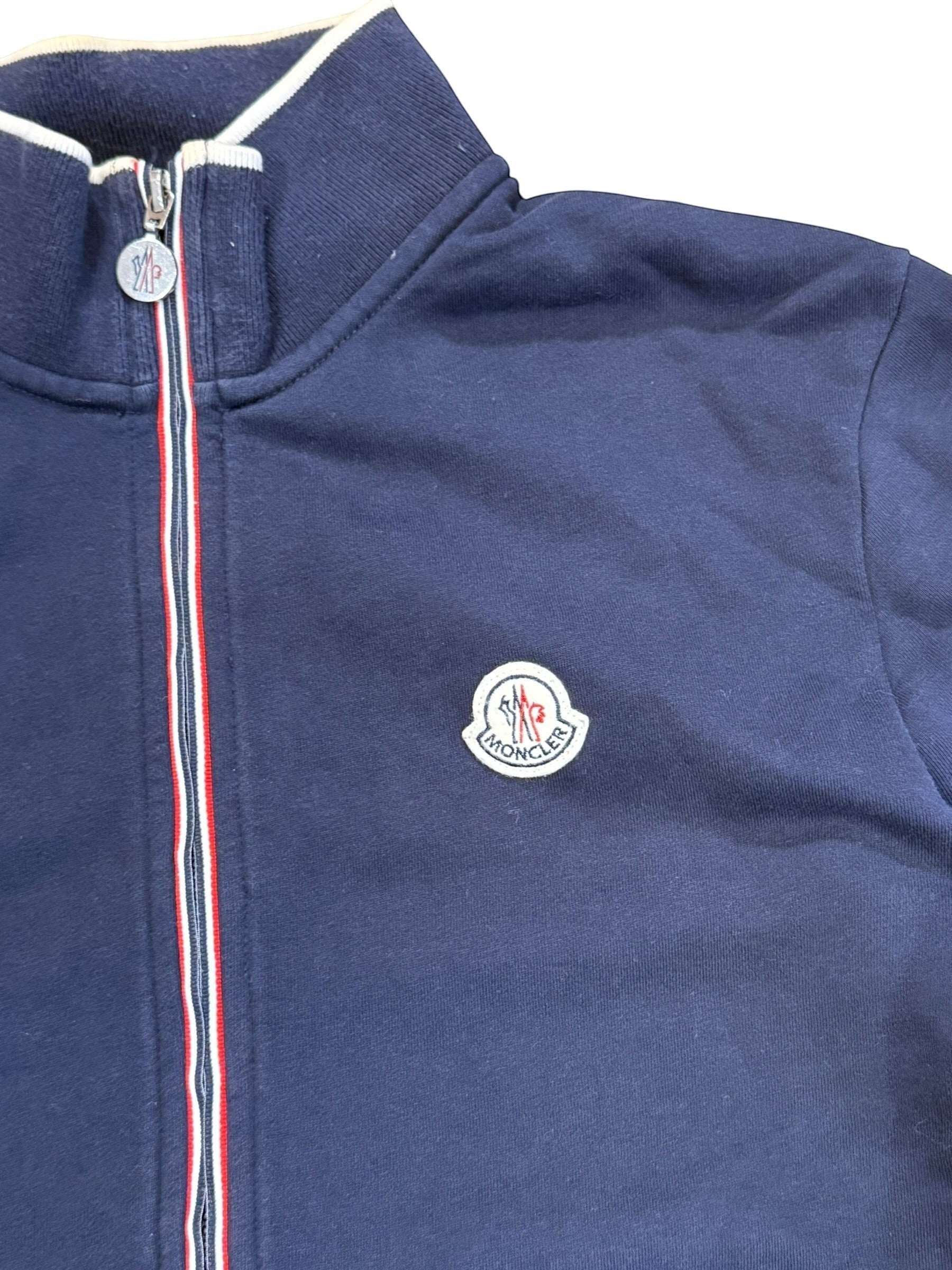 Archive No. 9 navy zip-up jumper with iconic Moncler badge on chest and branded zip pulls.
