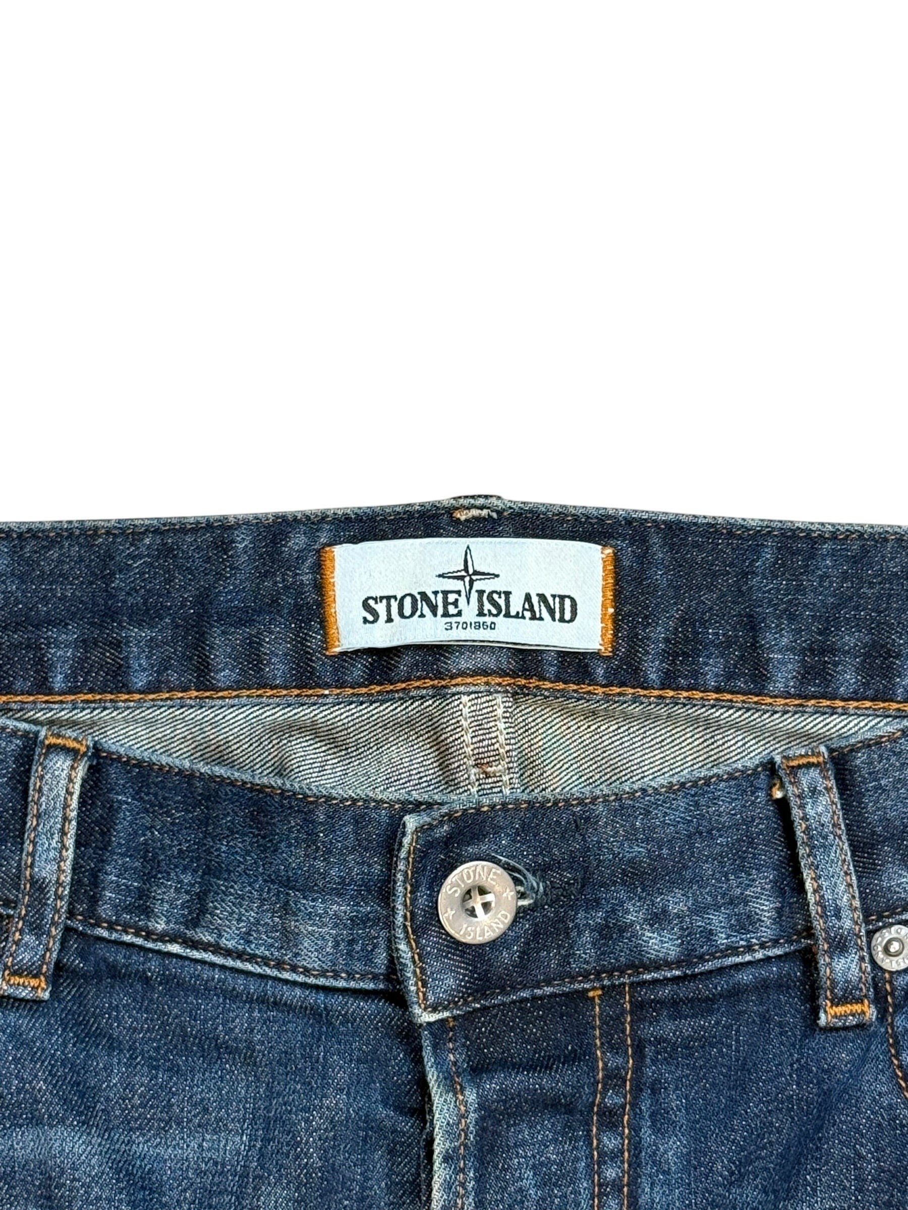 Archive No. 9 navy denim jeans with Stone Island logo button and leather patch detail. Size W34.