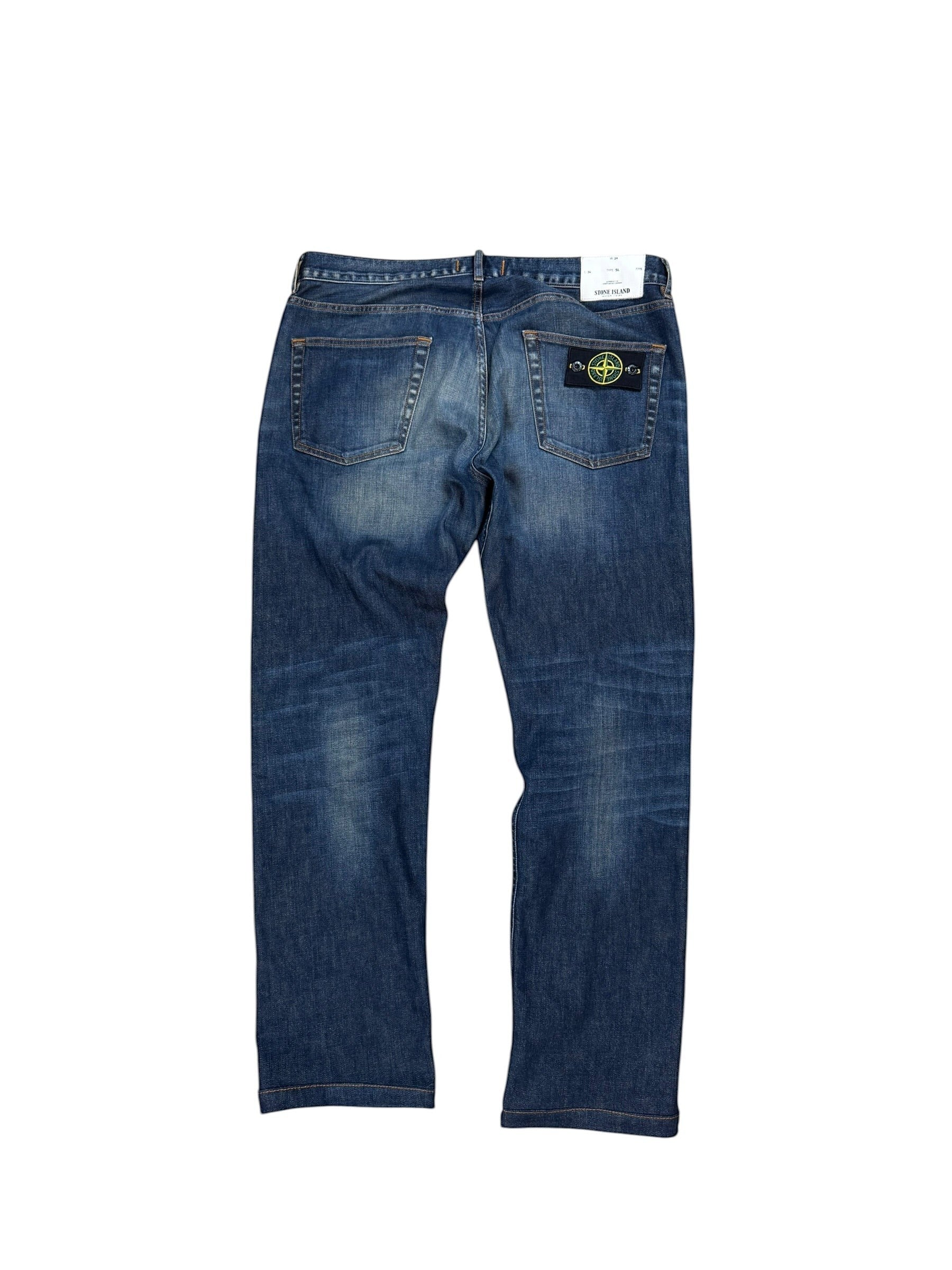Archive No. 9 vintage navy blue denim jeans with Stone Island compass badge on back pocket, size W34.