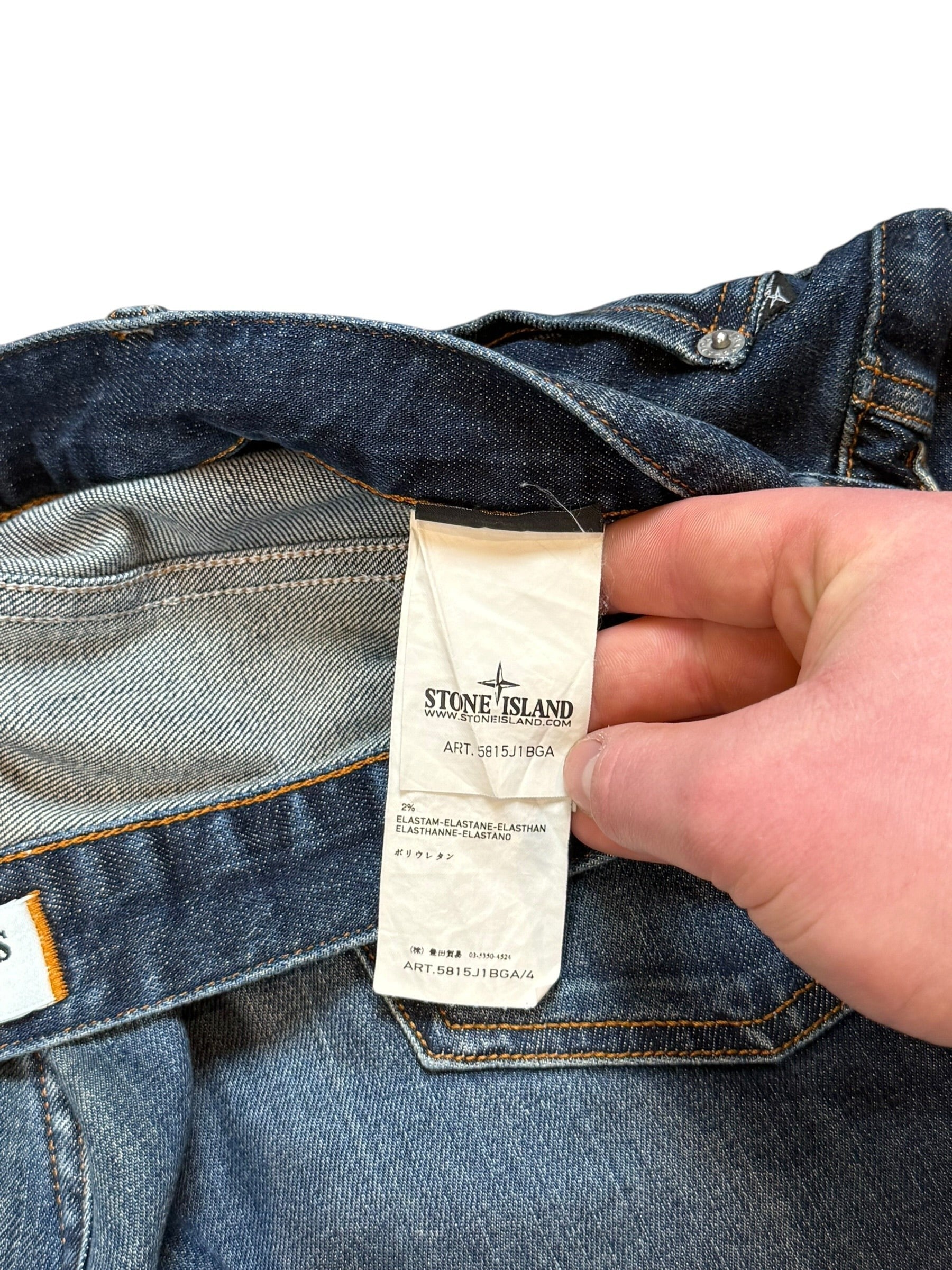 Archive No. 9 navy blue denim jeans with Stone Island compass badge detail and leather accents, size W34.