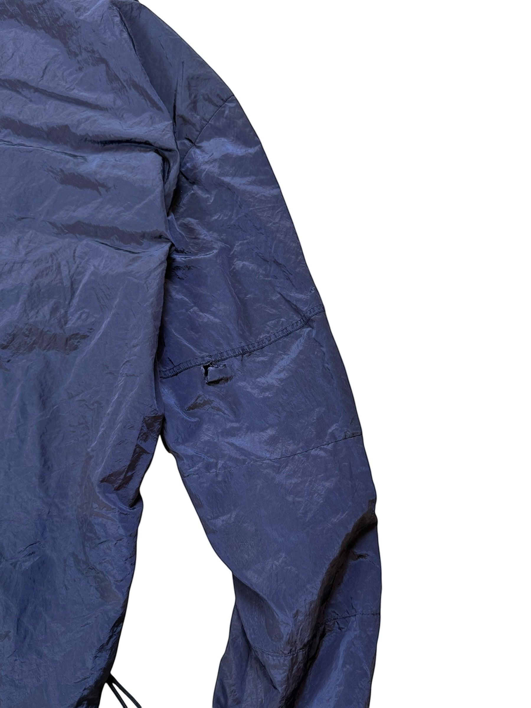 Archive No. 9 navy Stone Island nylon metal jacket, size M. Lightweight technical design with a small rip on the back of the arm.
