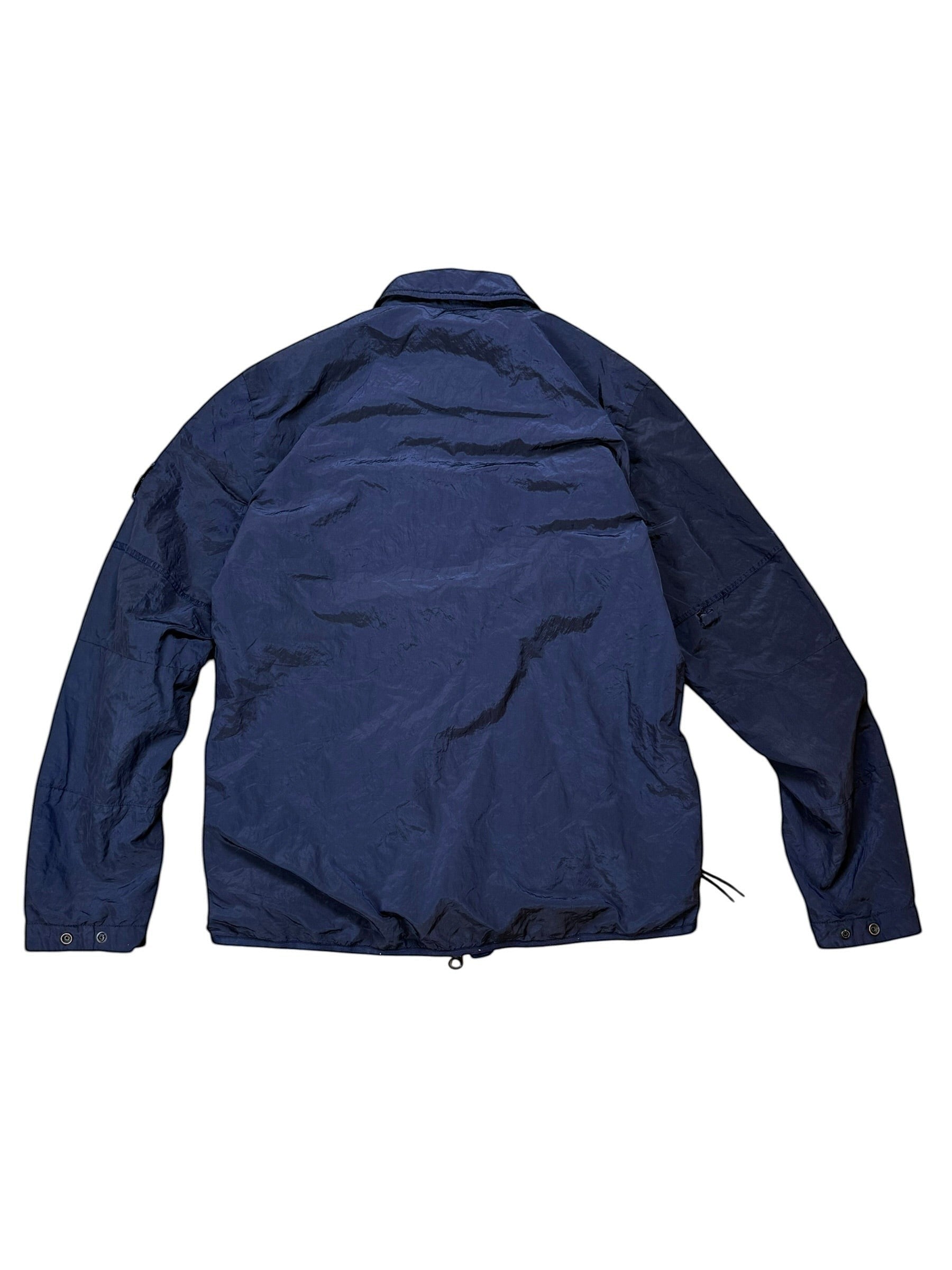 Archive No. 9 navy Stone Island nylon metal jacket, size M, lightweight technical design with a small rip on the back of the arm.