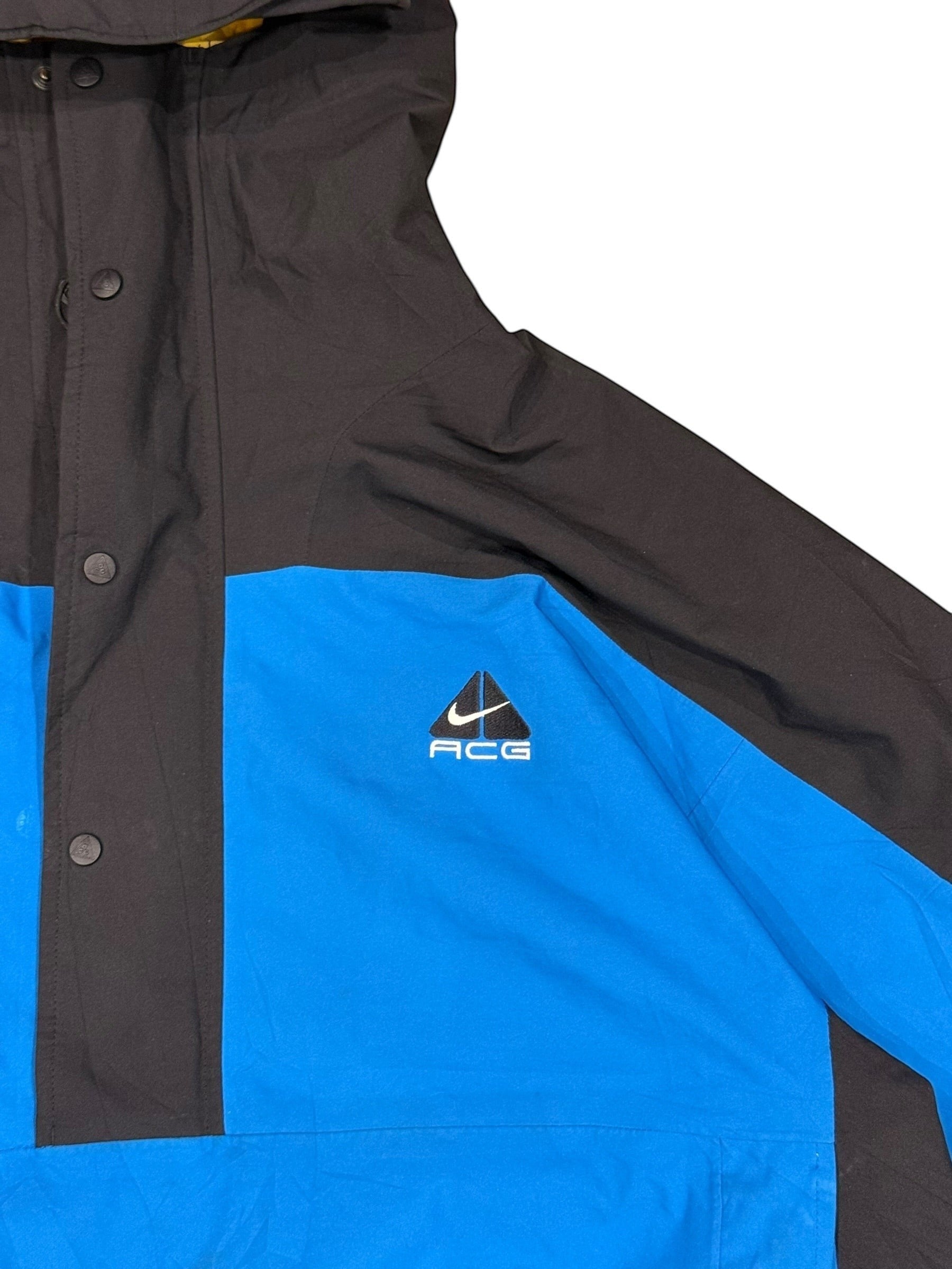 Archive No. 9 vintage Nike ACG black and blue windbreaker jacket, size Large. Features waterproof material and ACG logo.