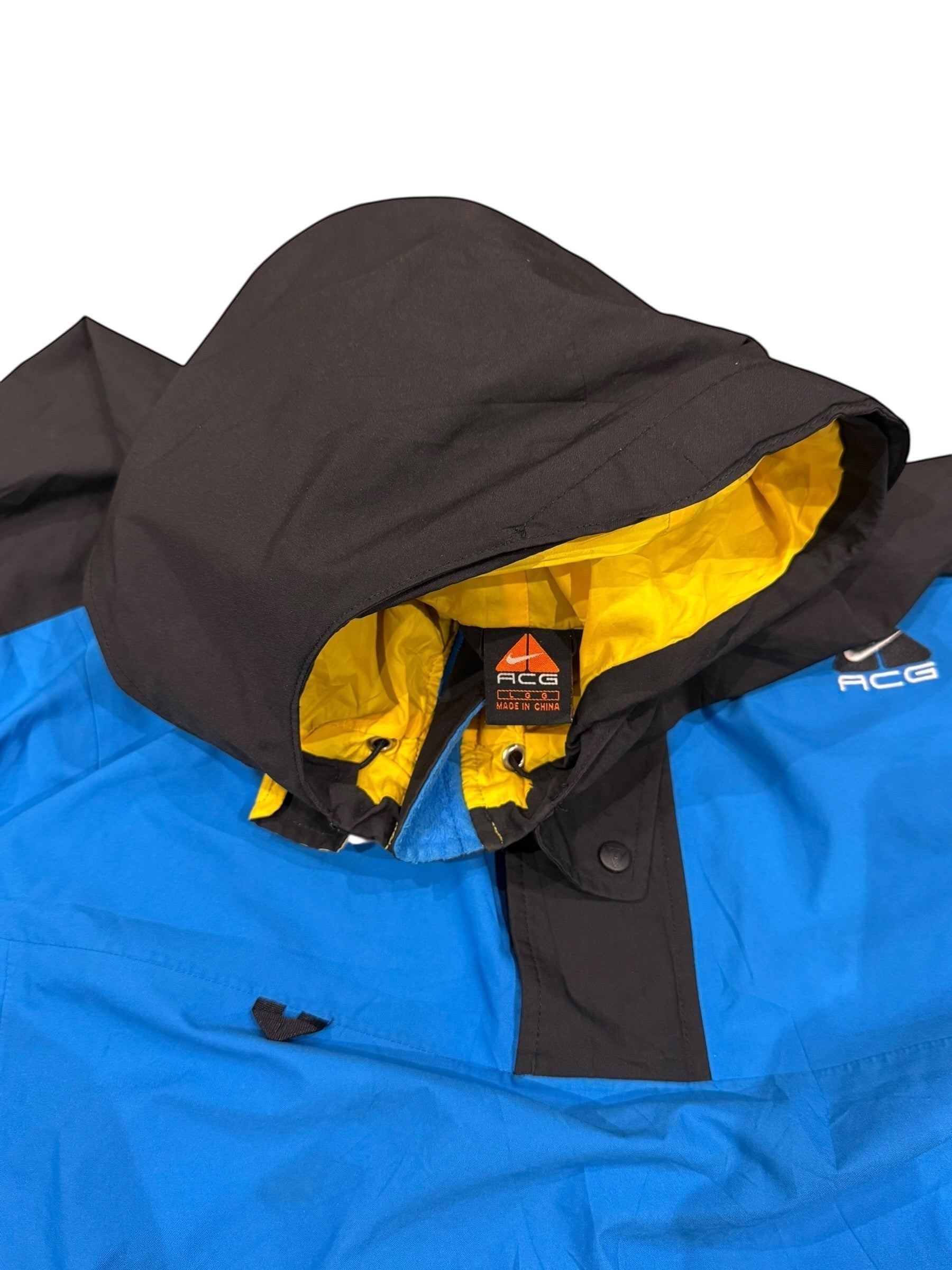 Archive No. 9 vintage Nike ACG black and blue windbreaker jacket, size Large. Features yellow lining and waterproof material.
