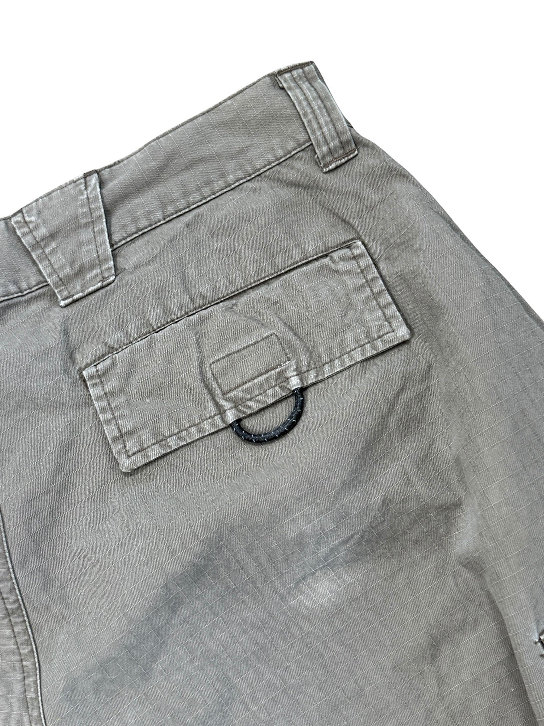 Archive No.9 grey Nike ACG technical shorts with multiple pockets and a D-ring detail on the back pocket.