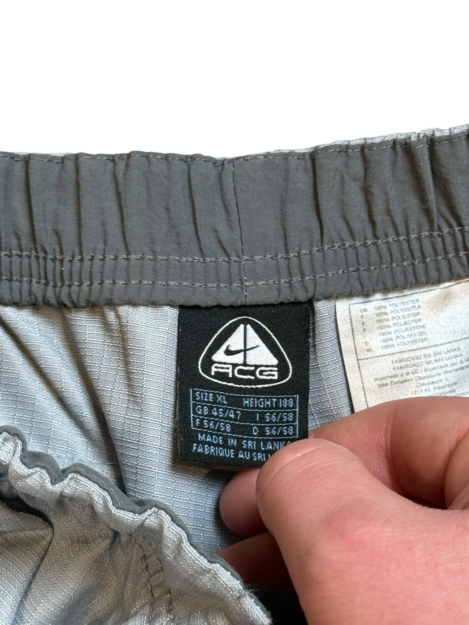 Archive No. 9 vintage grey Nike ACG technical shorts, waterproof and wind-resistant, size XL.