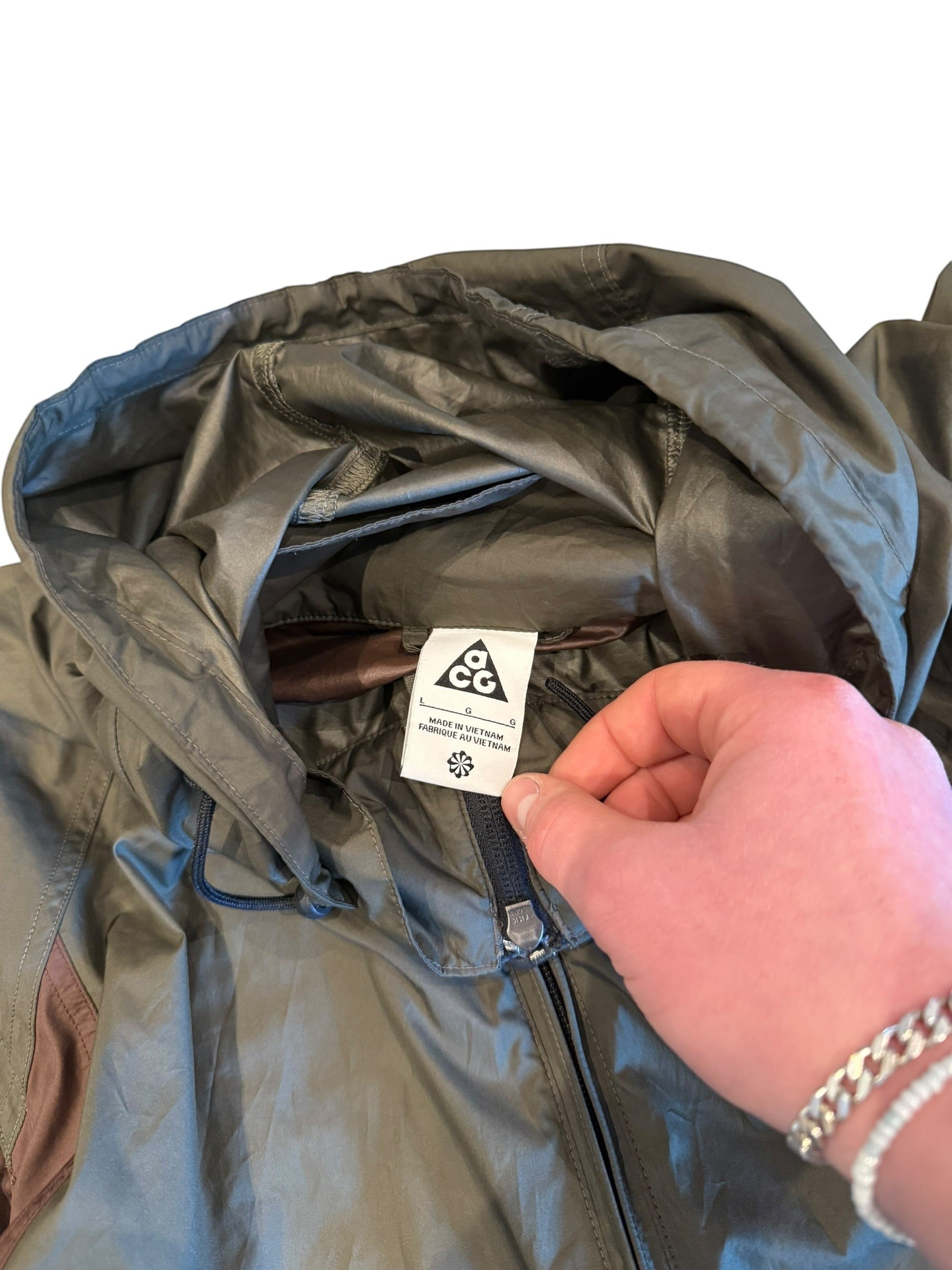 Archive No. 9 Nike ACG windbreaker jacket in burgundy and khaki, size L. Lightweight, water and wind-resistant.