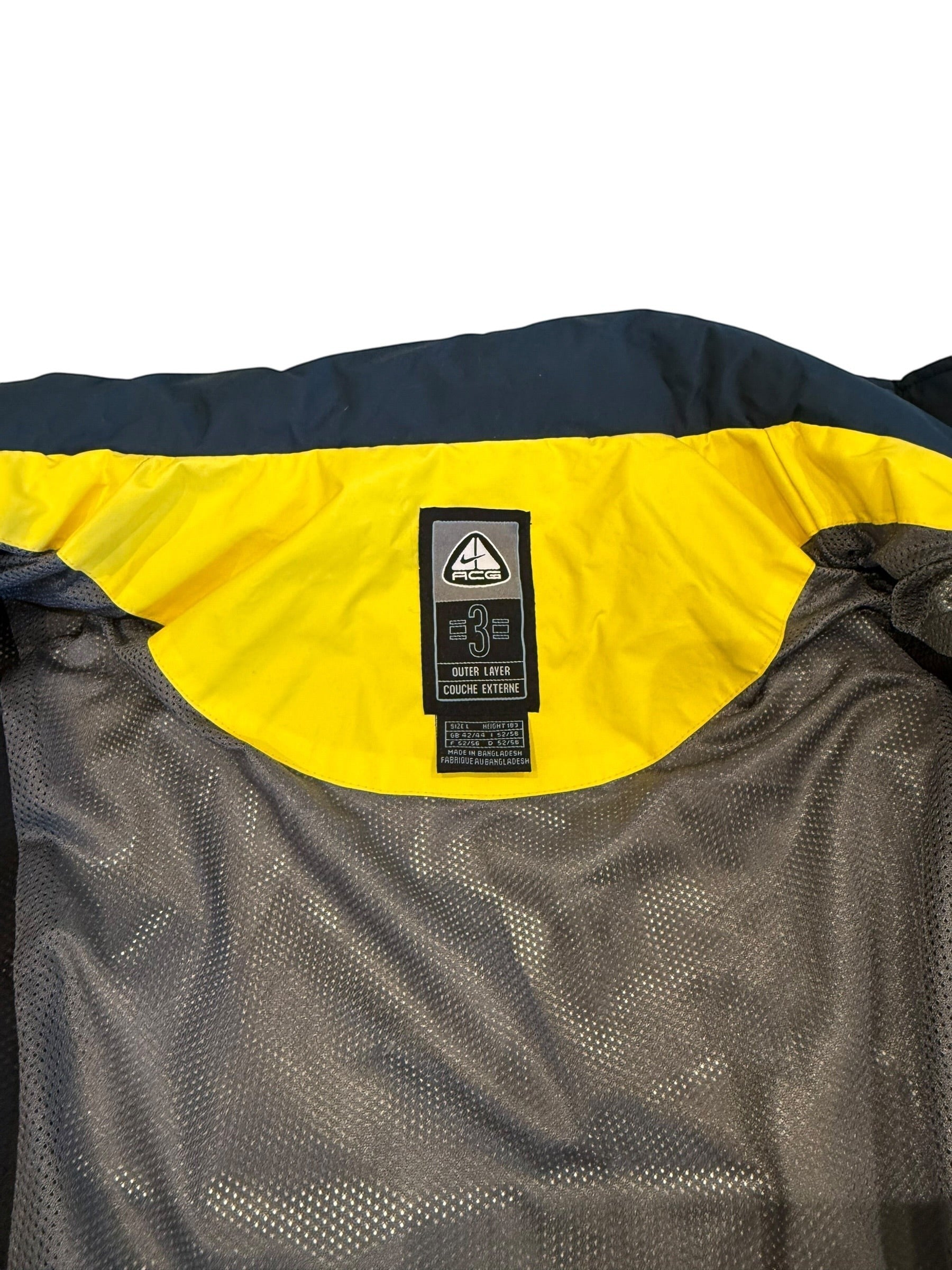 Archive No. 9 Nike ACG yellow ski jacket, size Large, with mesh lining and ACG logo tag.