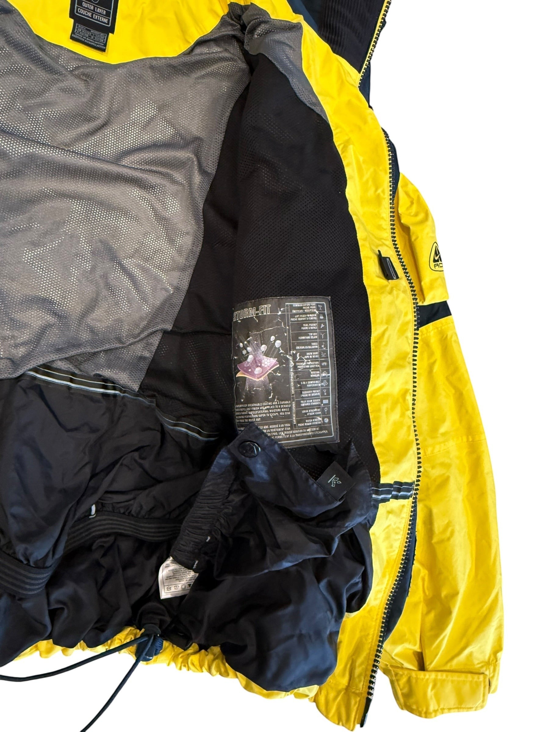 Archive No. 9 yellow Nike ACG ski jacket, size Large, with Storm-FIT technology for warmth and protection in cold, windy, and wet conditions.