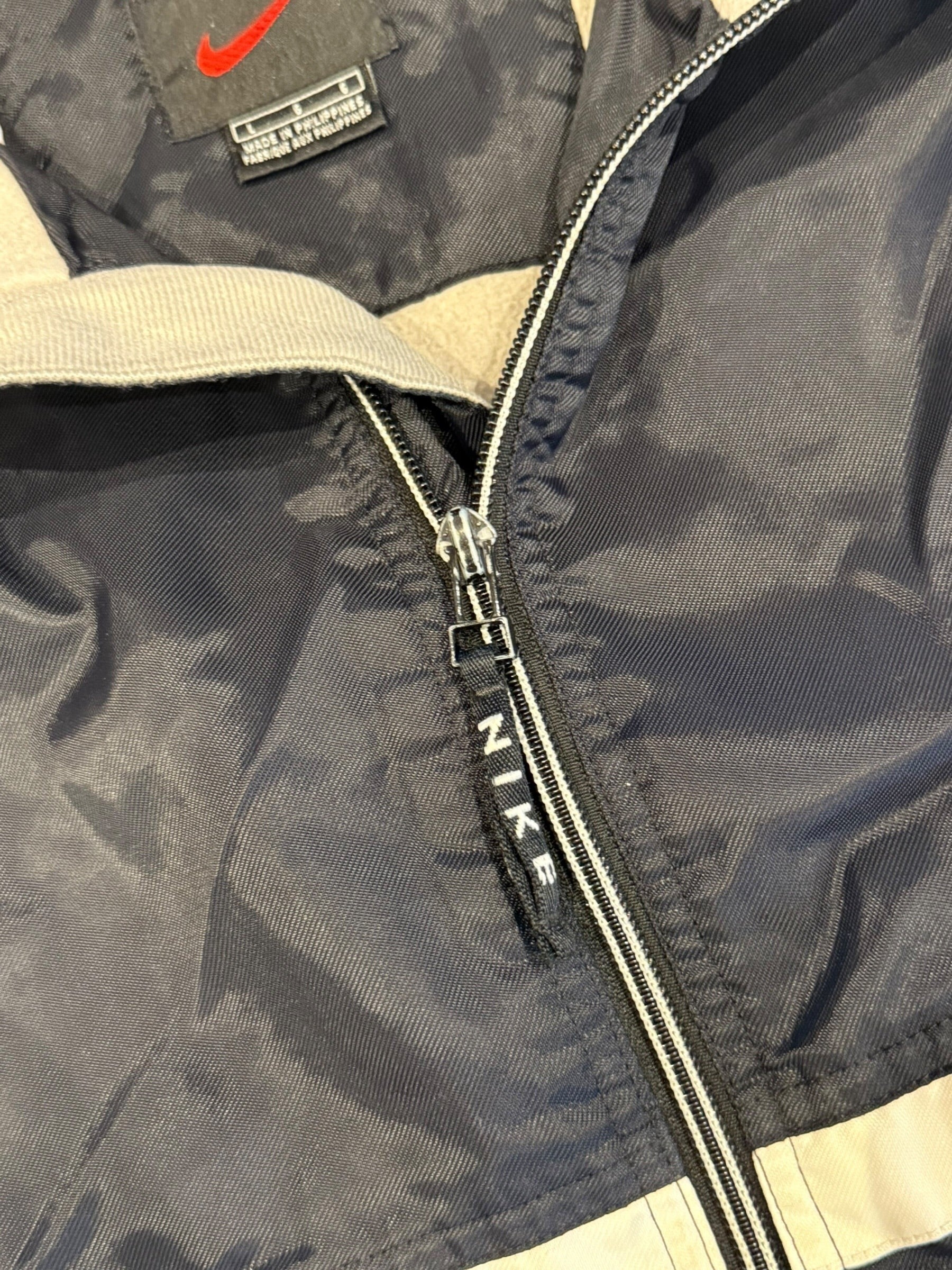 Archive No. 9 vintage black Nike training jacket, size L, water and wind resistant with beige accents.