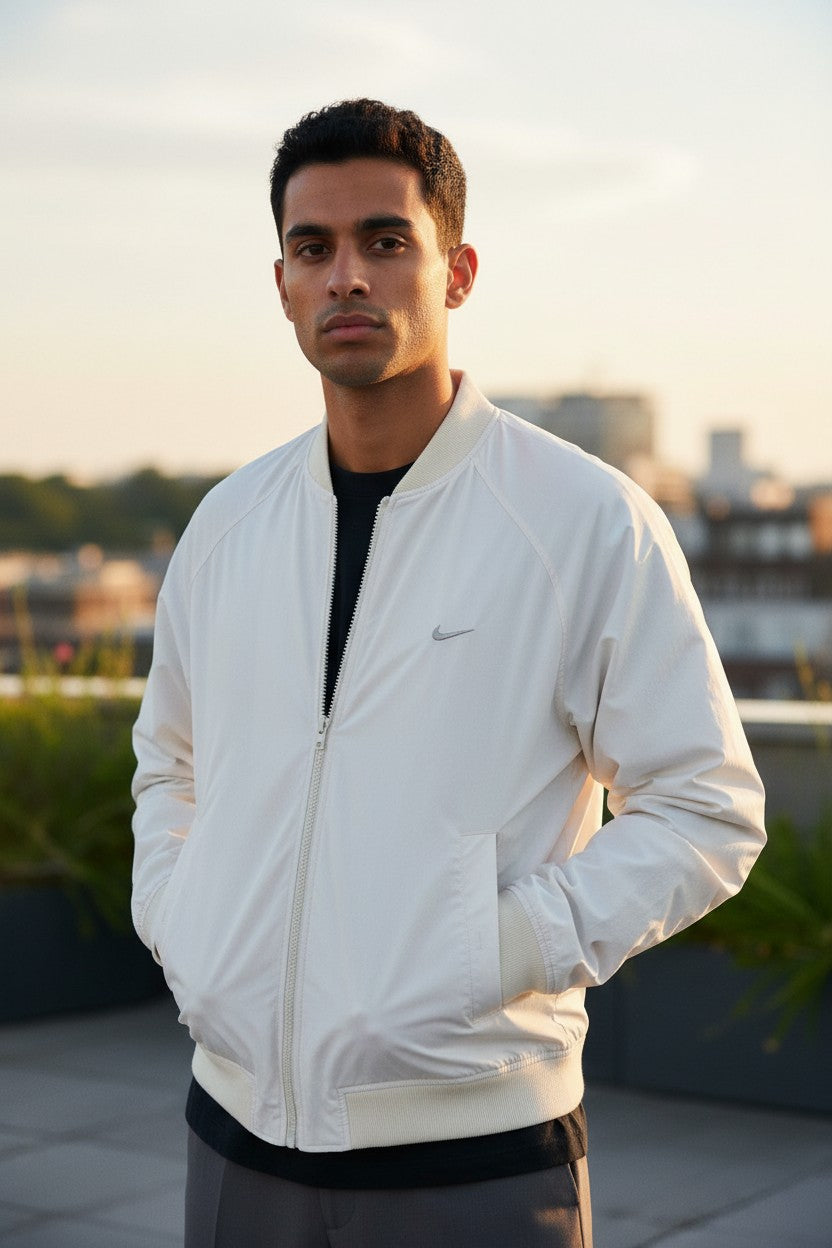 Archive No. 9 cream Nike bomber jacket, size Large, with zip closure and subtle Nike logo.