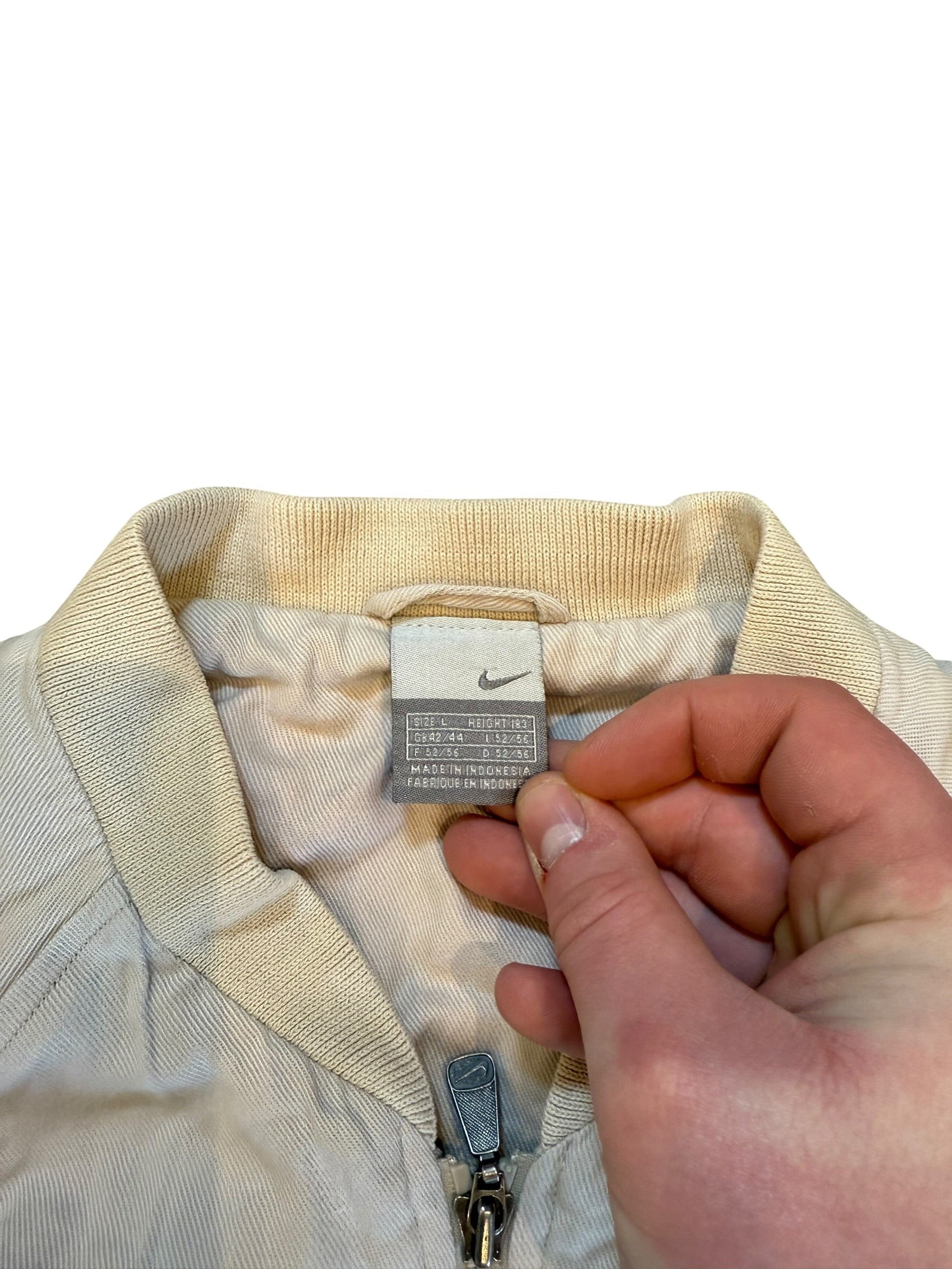 Archive No.9 Nike cream bomber jacket, size Large, with zip closure and ribbed collar. Casual style.