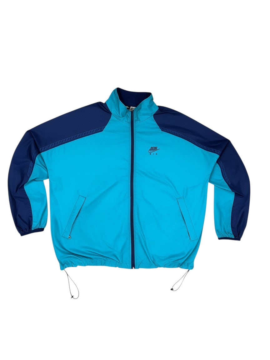 Archive No. 9 Nike windbreaker jacket in turquoise and purple, size Large. Lightweight, wind-resistant, and waterproof.