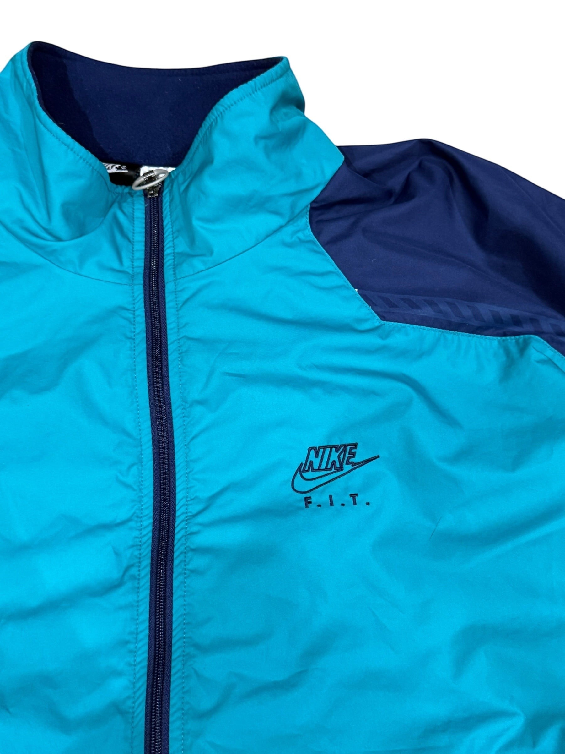 Archive No. 9 Nike windbreaker jacket in turquoise and navy blue, size Large. Lightweight, wind-resistant, and waterproof.