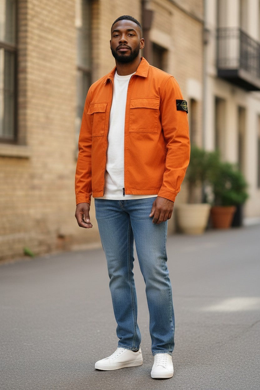 Archive No. 9 orange 100% cotton Stone Island overshirt with zip closure, two chest pockets, and signature compass badge on the arm. Size M.